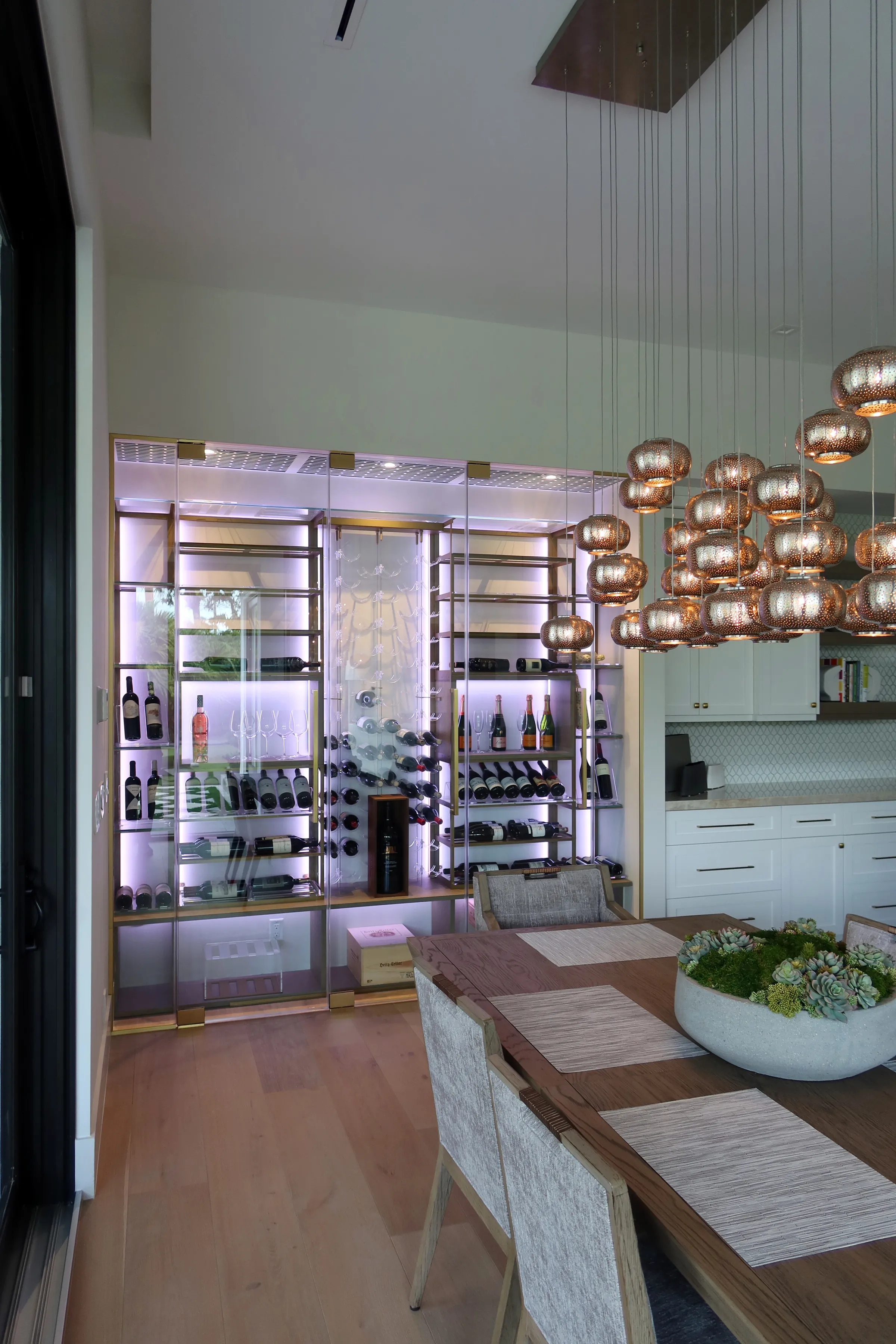 Custom wine wall Miami featuring glass enclosure, illuminated bottle displays, and contemporary luxury wine storage — photograph 1 of 3