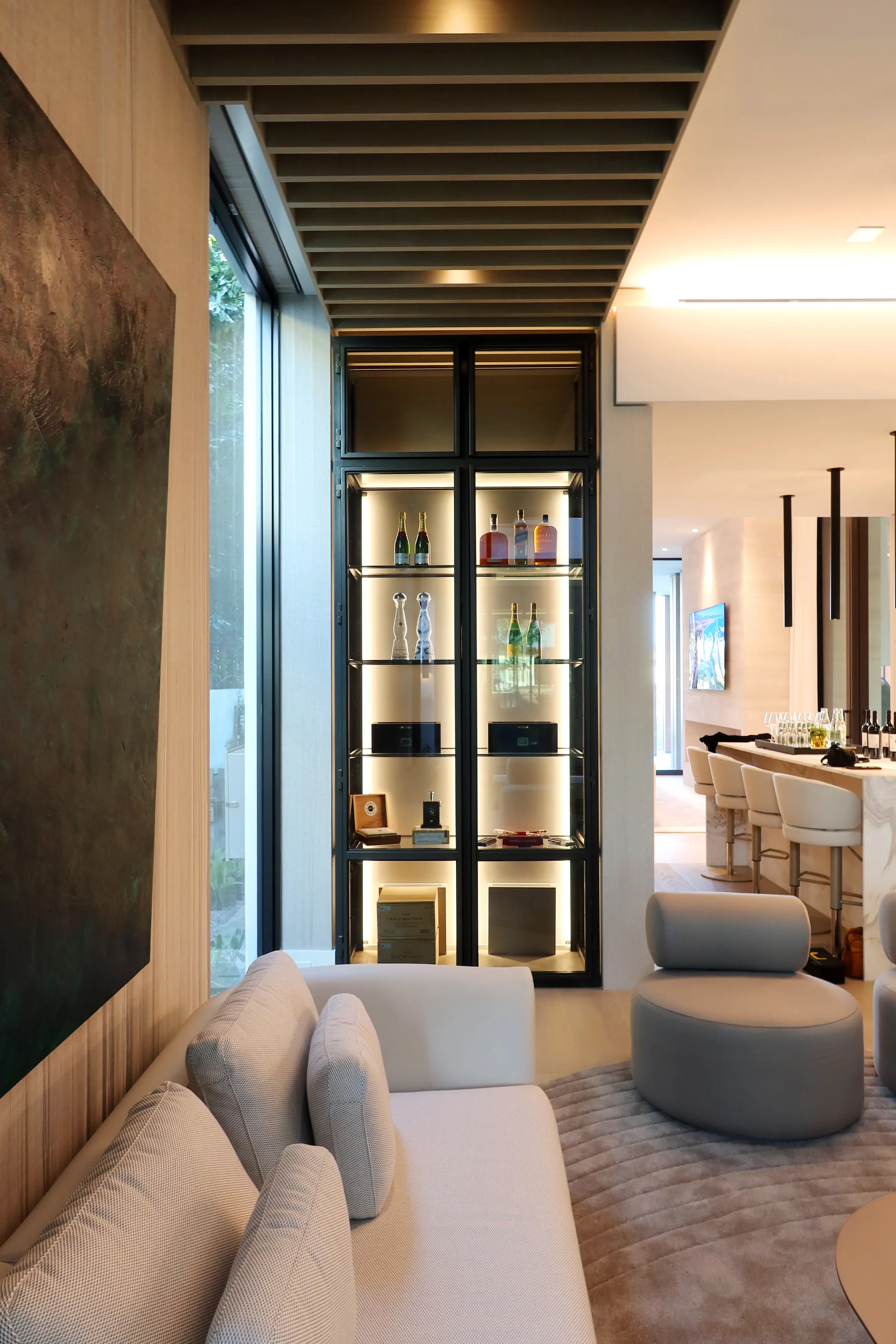 Custom dual wine wall Palm Beach featuring glass enclosure, illuminated bottle displays, and modern luxury wine storage — photograph 1 of 4