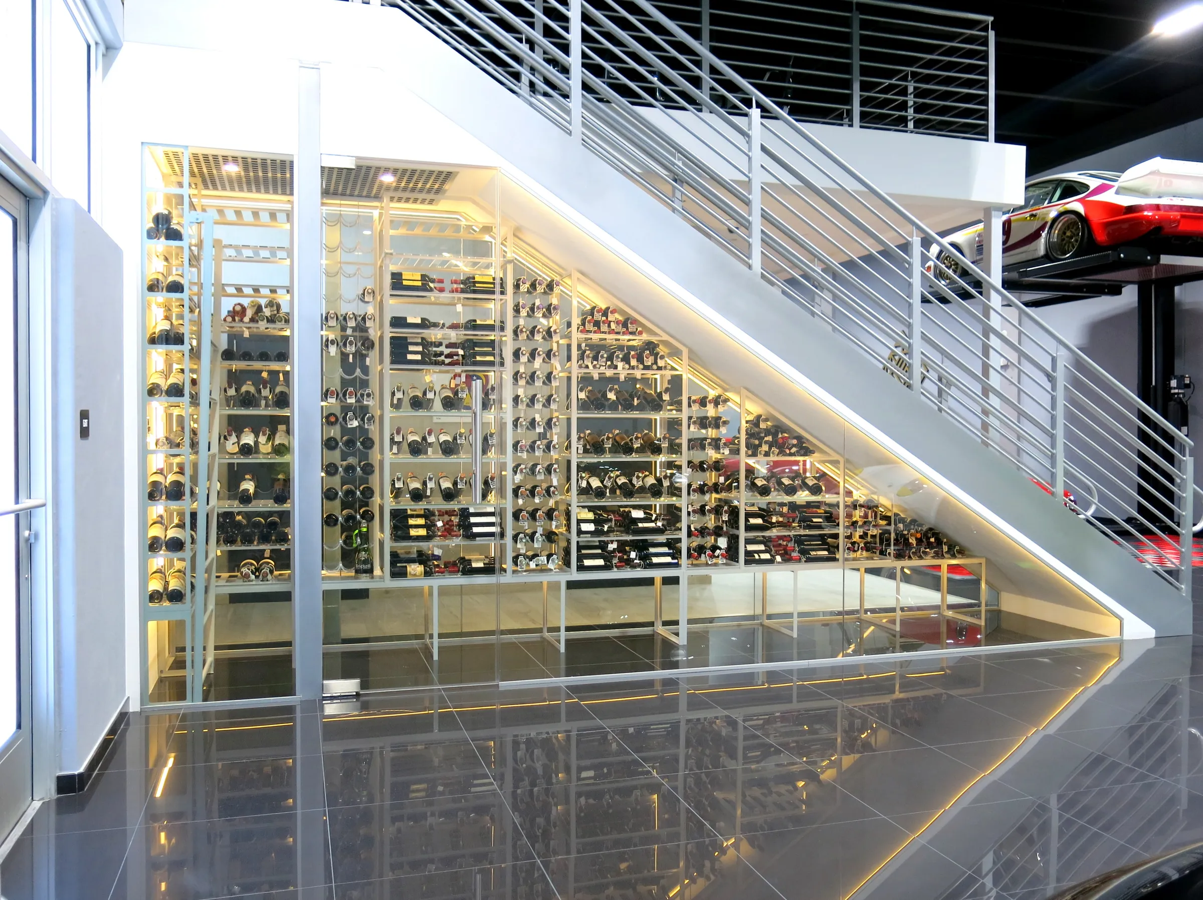 Custom understairs wine cellar miami featuring glass enclosure, metal and illuminated wine racks , modern design — photograph 3 of 4