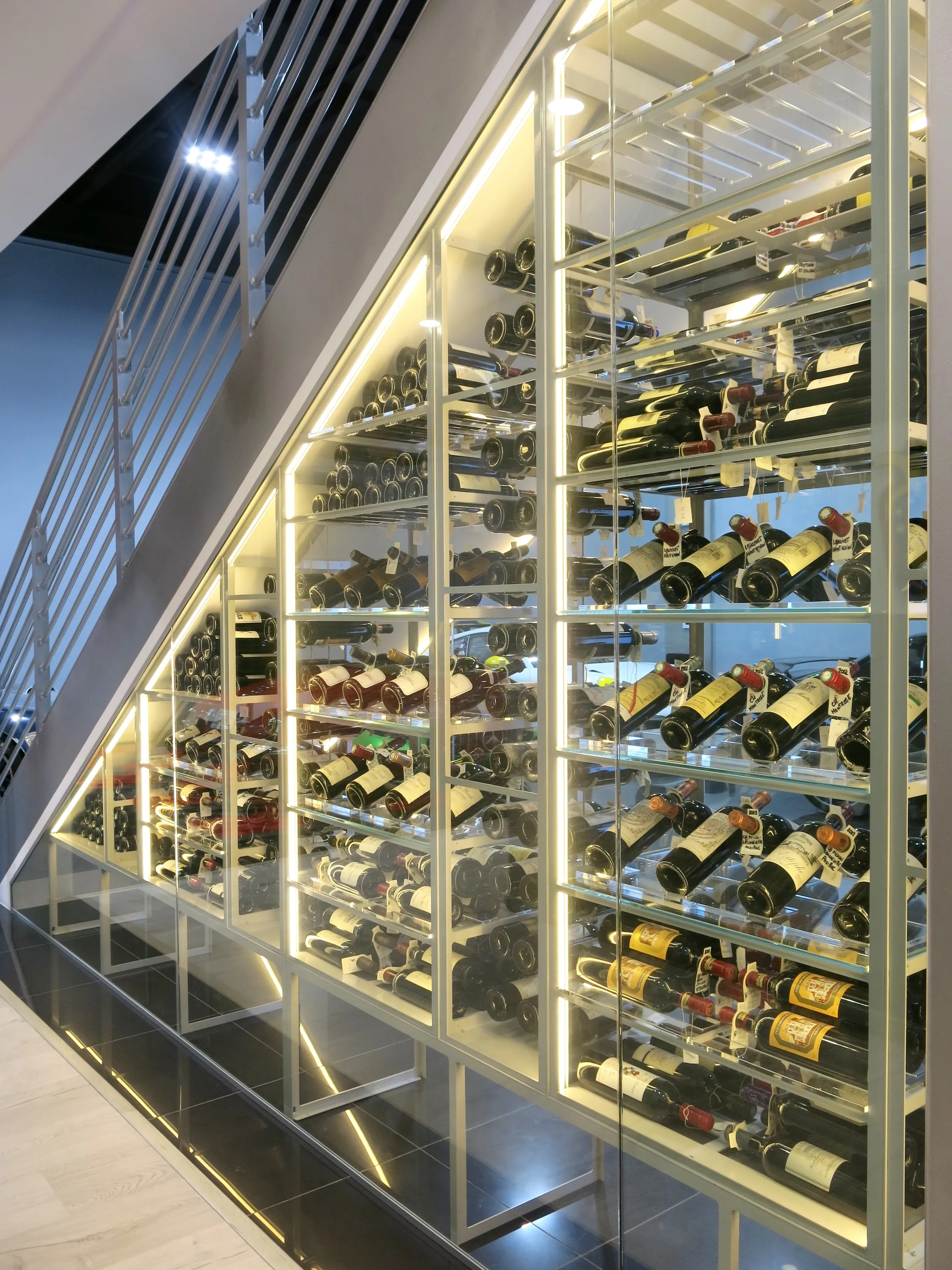 Custom understairs wine cellar miami featuring glass enclosure, metal and illuminated wine racks , modern design — photograph 4 of 4