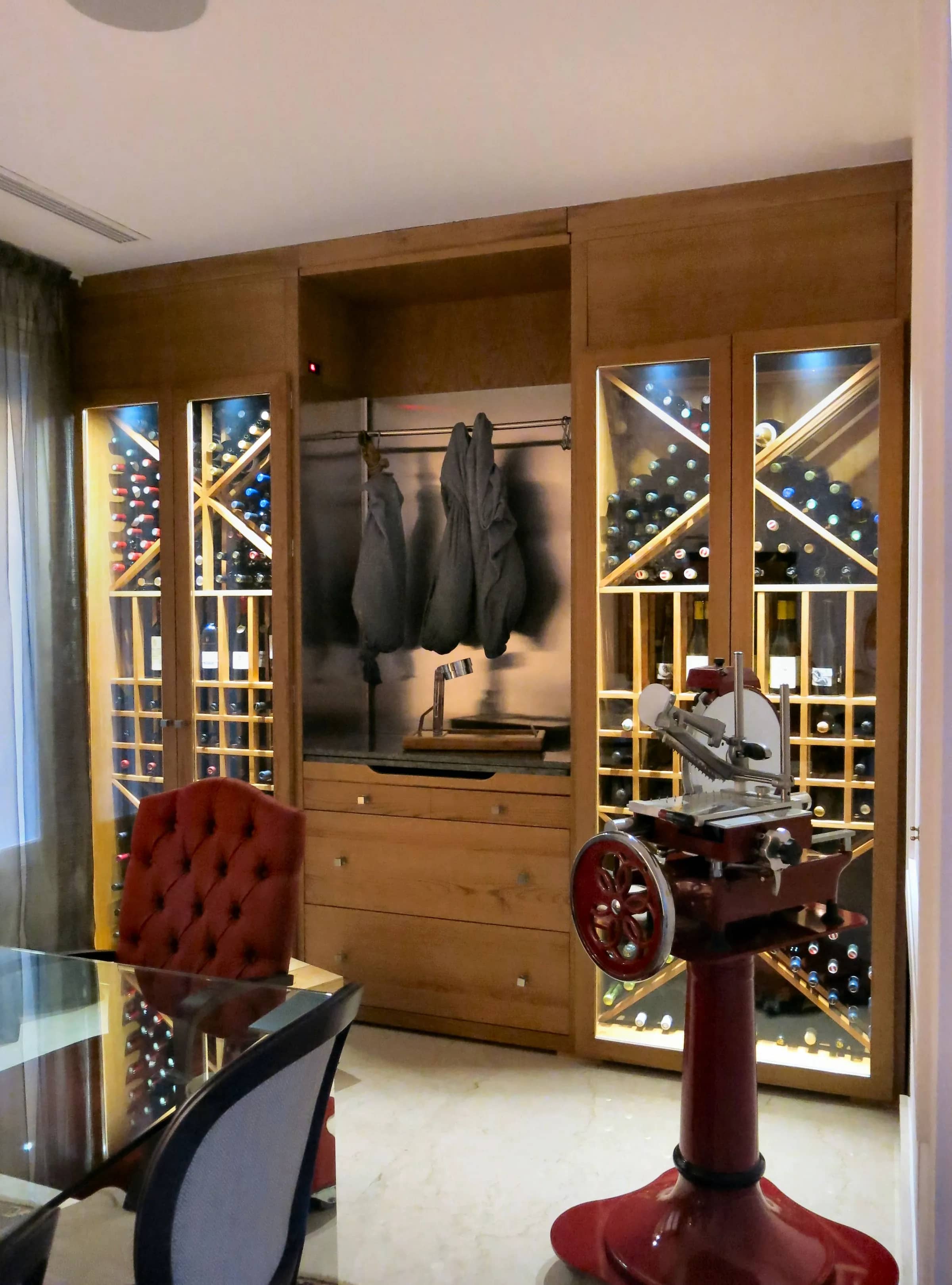 Commercial wine cellar design with curated wine display and elegant glass enclosures at Vinoteca Velazquez