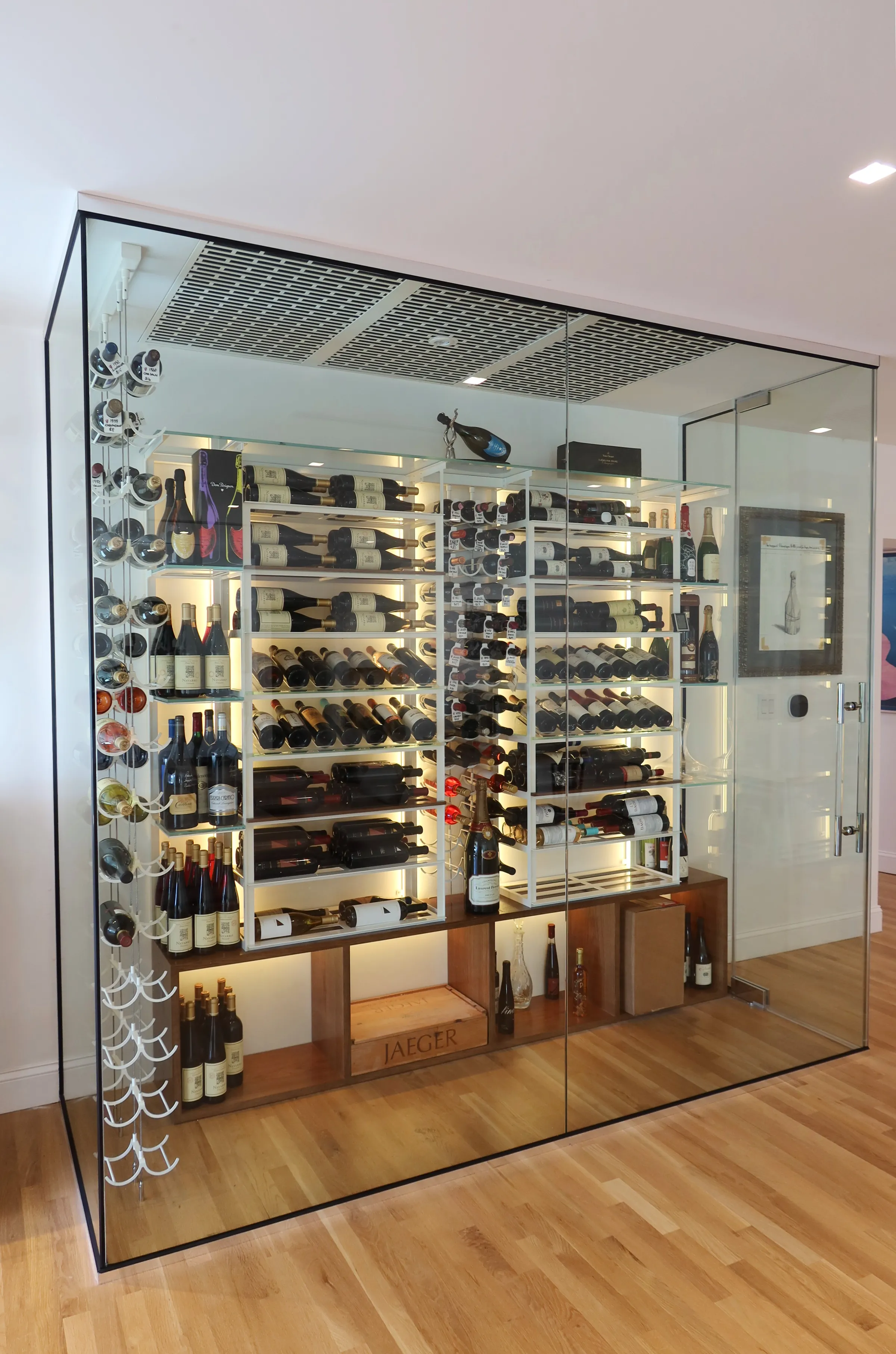 Luxury glass wine room Miami featuring custom floor-to-ceiling metal and wooden wine racks, LED lighting, and bar — photograph 1 of 6