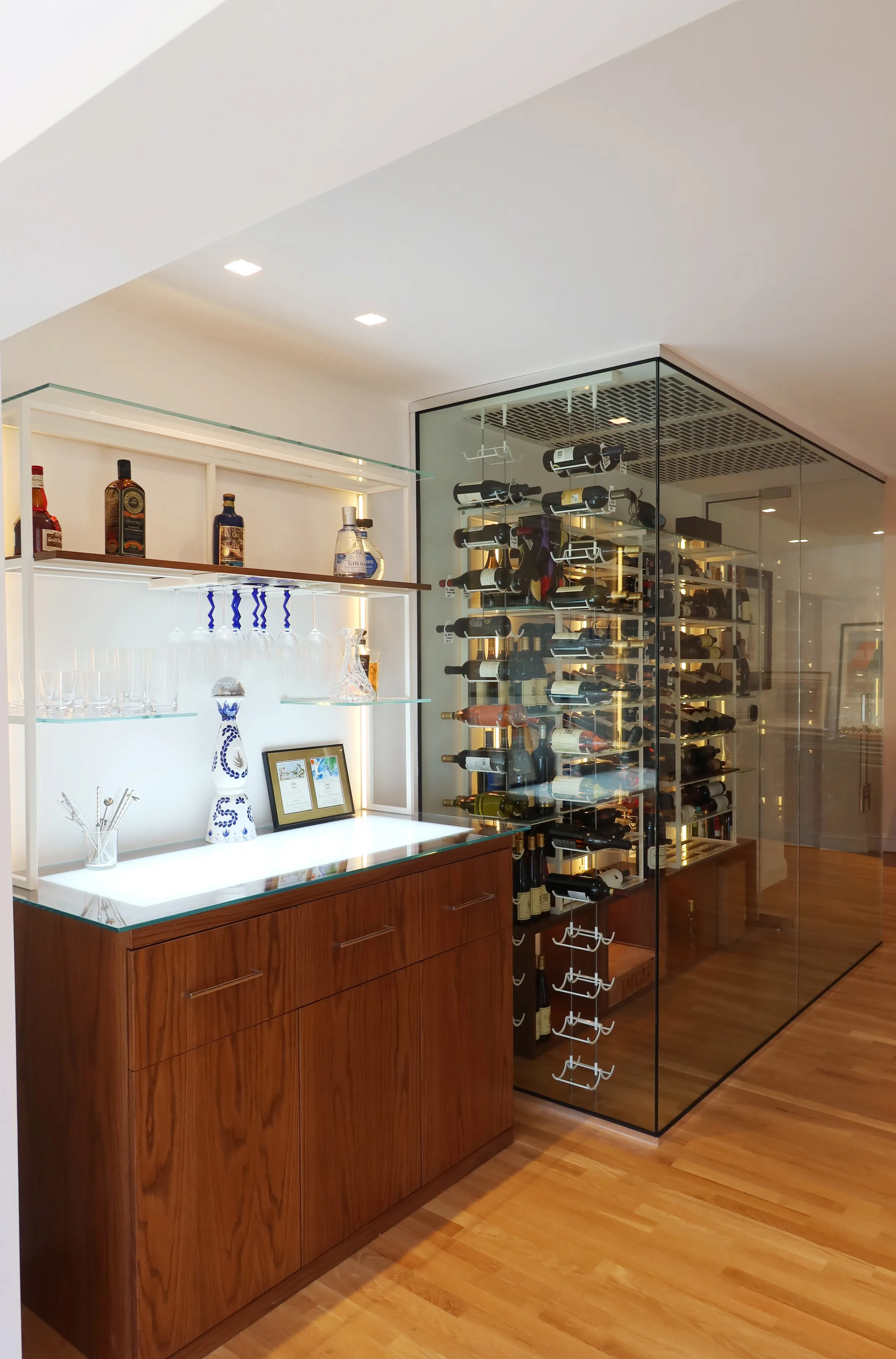 Luxury glass wine room Miami featuring custom floor-to-ceiling metal and wooden wine racks, LED lighting, and bar — photograph 2 of 6