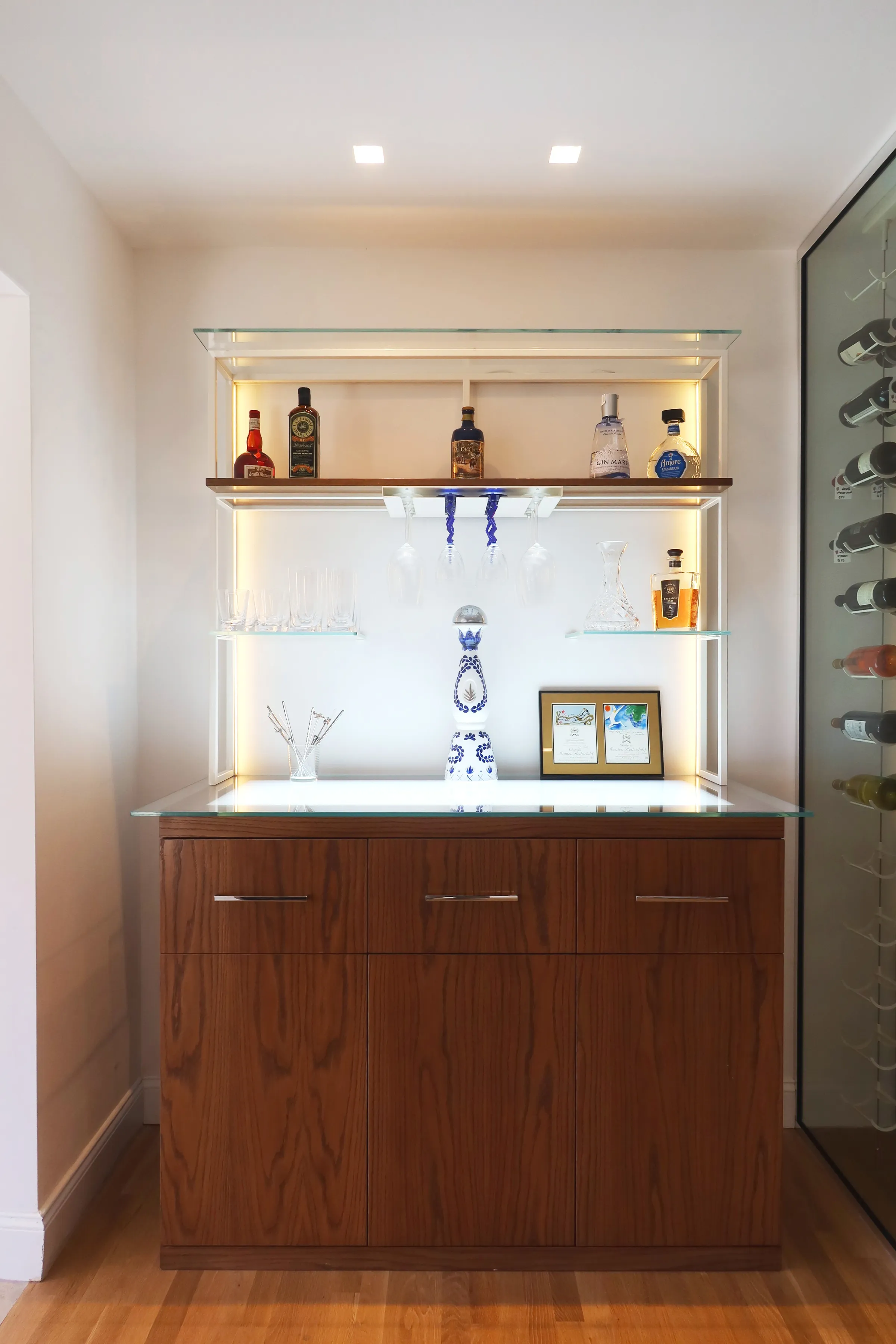 Luxury glass wine room Miami featuring custom floor-to-ceiling metal and wooden wine racks, LED lighting, and bar — photograph 4 of 6