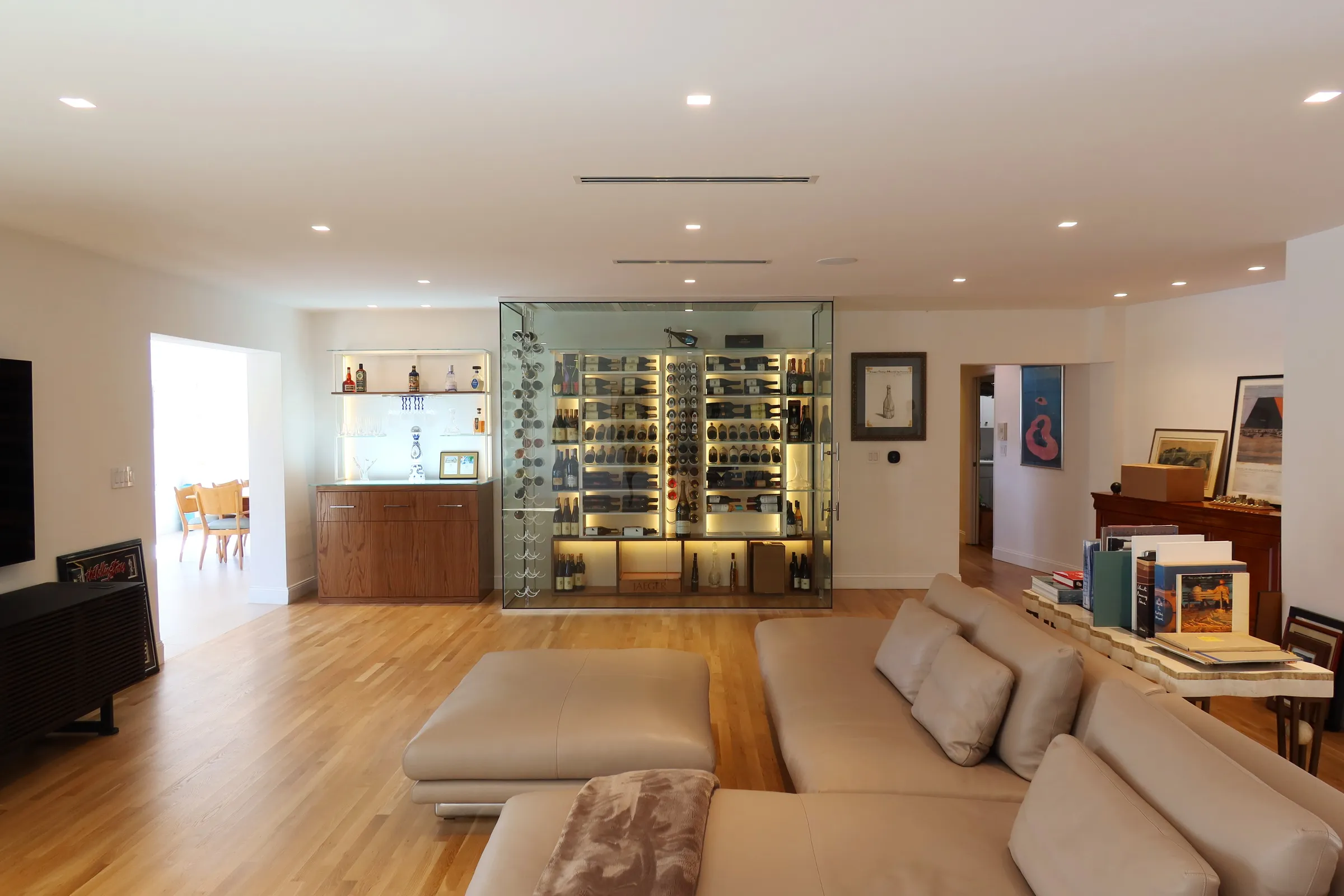 Luxury glass wine room Miami featuring custom floor-to-ceiling metal and wooden wine racks, LED lighting, and bar — photograph 6 of 6