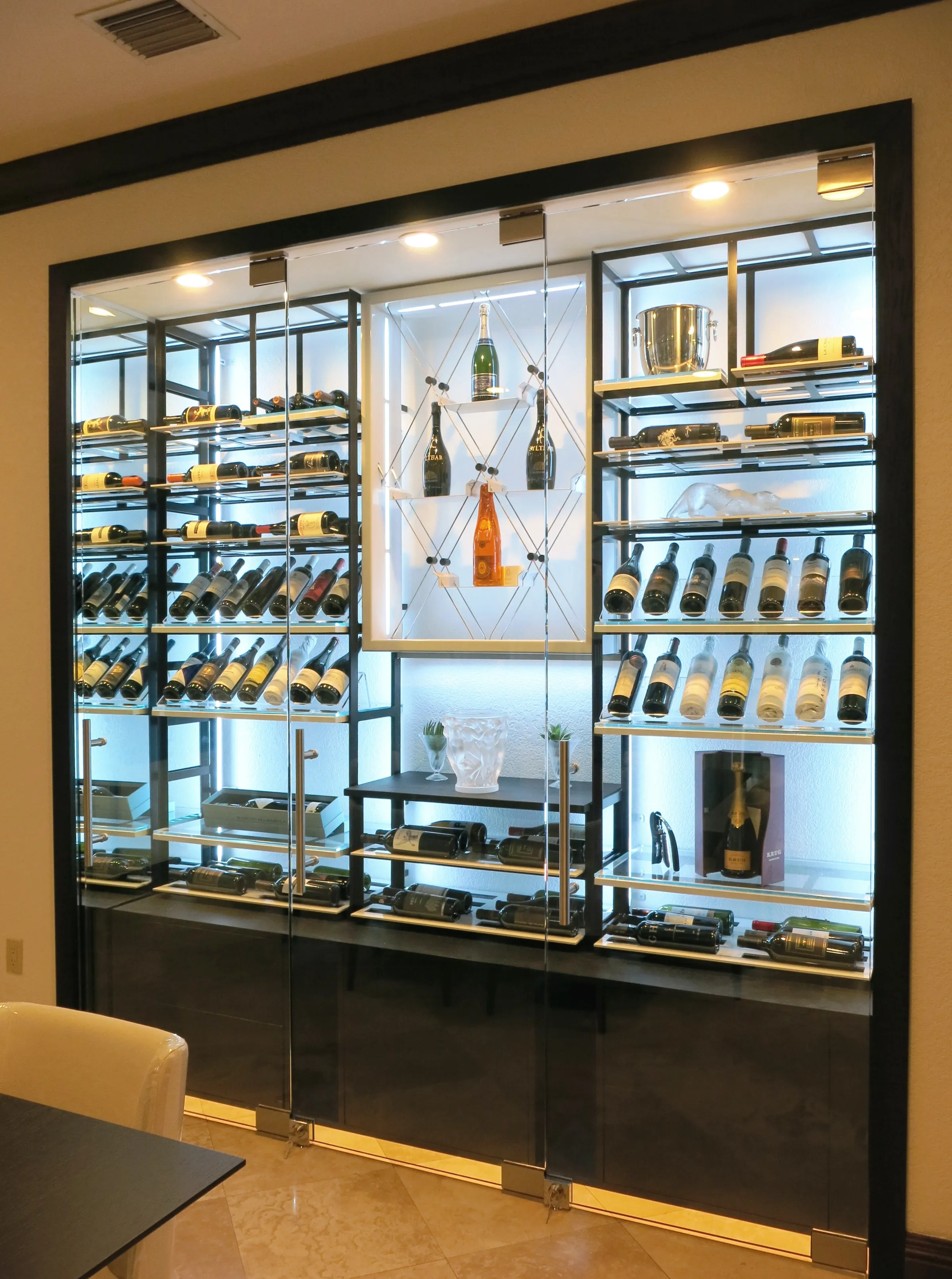 Custom wine wall Miami featuring glass enclosure, illuminated bottle displays, and modern luxury wine storage — photograph 1 of 3