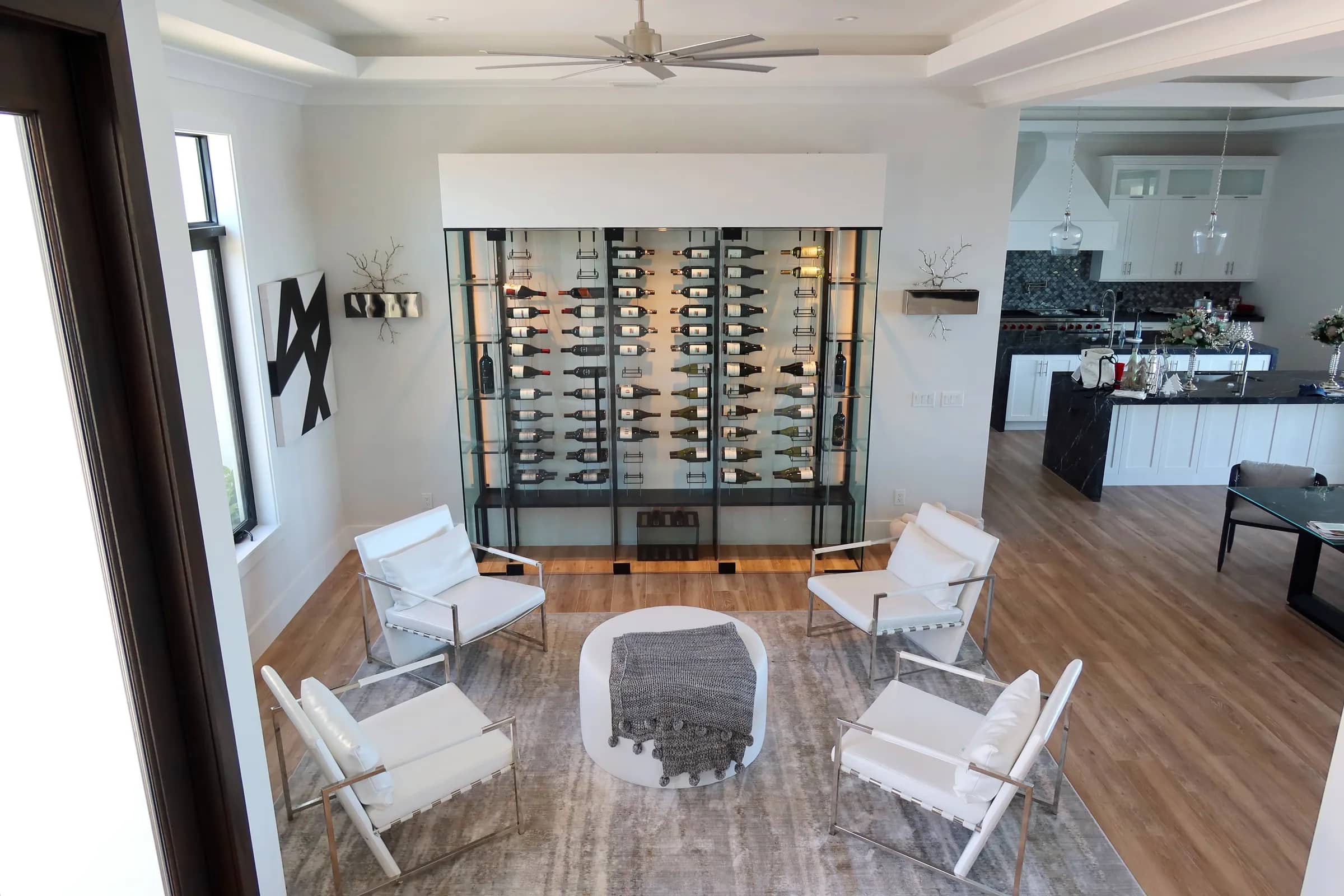 custom wine wall North Palm Beach Florida, black lacquered hooks, metal racks, warm white LED lighting, glass shelving, wine crates storage — photograph 1 of 3