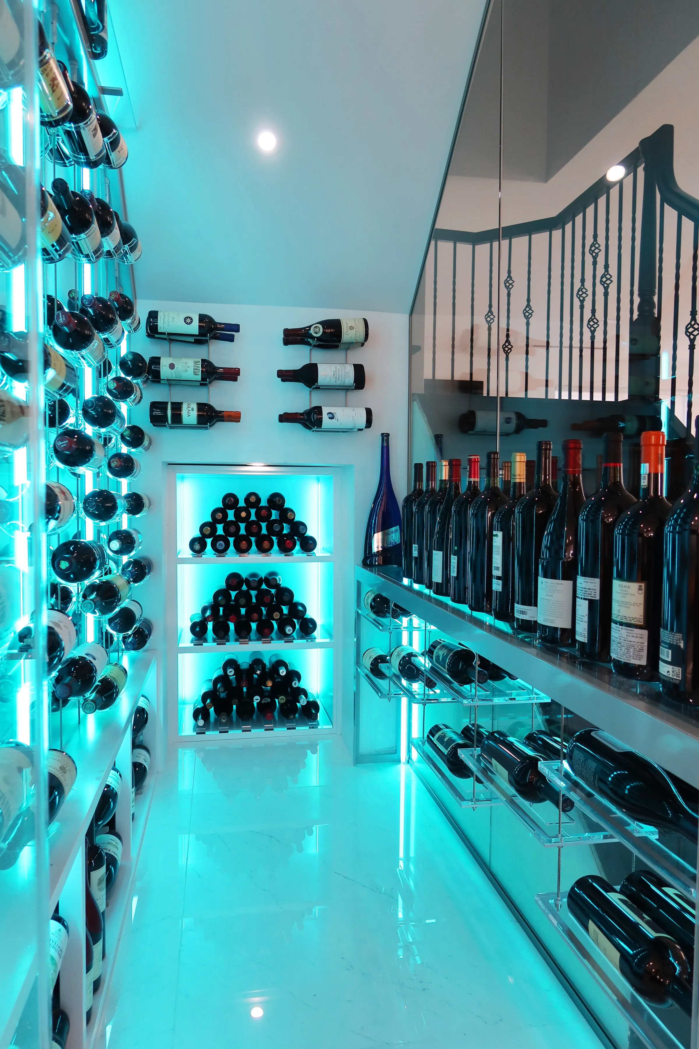 Custom understairs wine cellar Miami featuring glass enclosure, illuminated wine racks, and luxury wine storage design — photograph 3 of 3