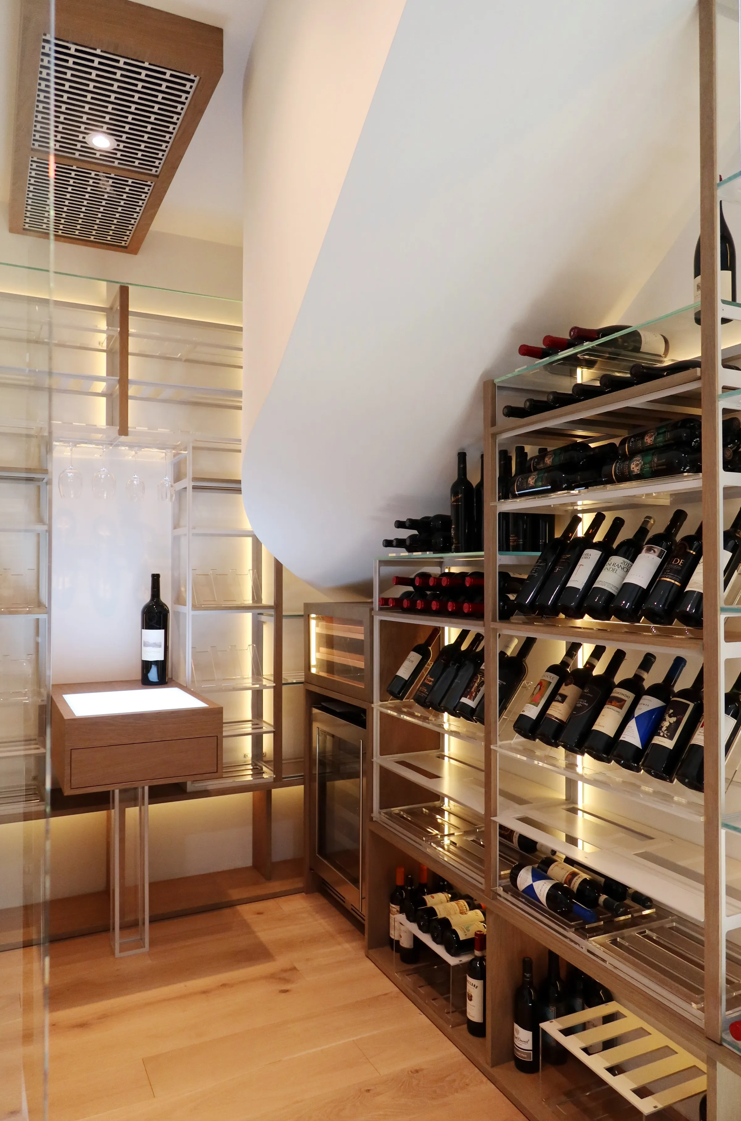 Custom understairs wine cellar miami featuring glass enclosure, metal and wooden illuminated wine racks design — photograph 1 of 4