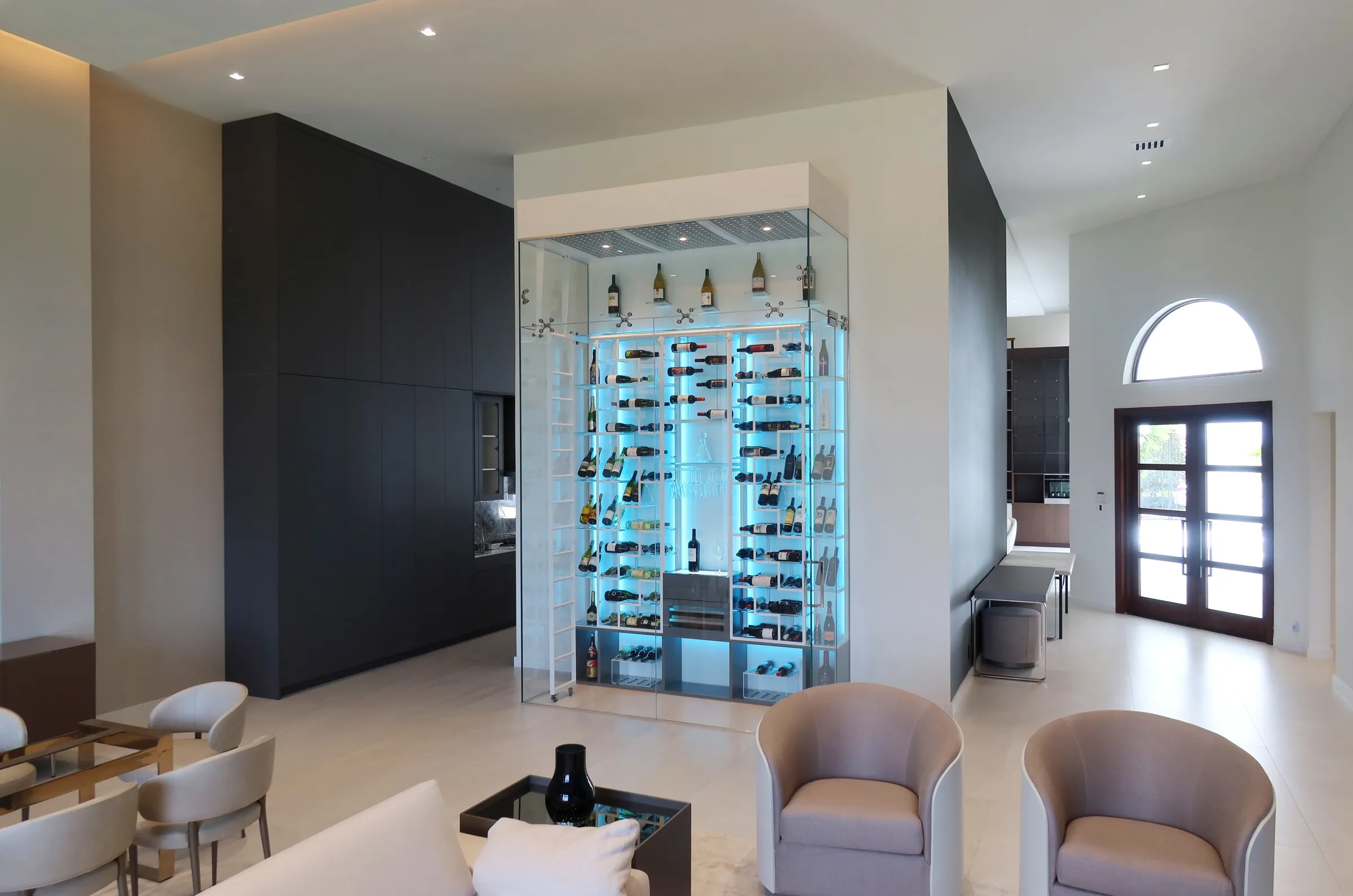 Luxury glass wine cellar Miami featuring custom floor-to-ceiling metal wine racks, LED lighting, and humidor — photograph 2 of 6