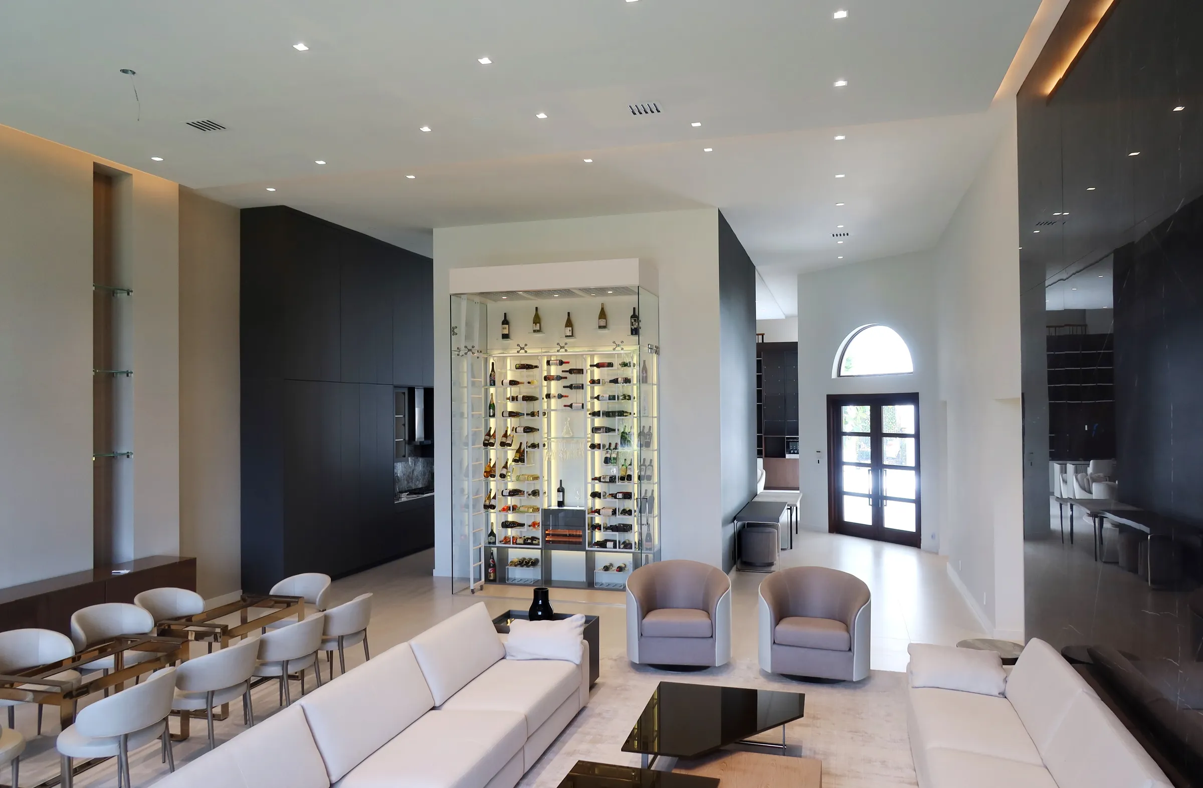 Luxury glass wine cellar Miami featuring custom floor-to-ceiling metal wine racks, LED lighting, and humidor — photograph 4 of 6