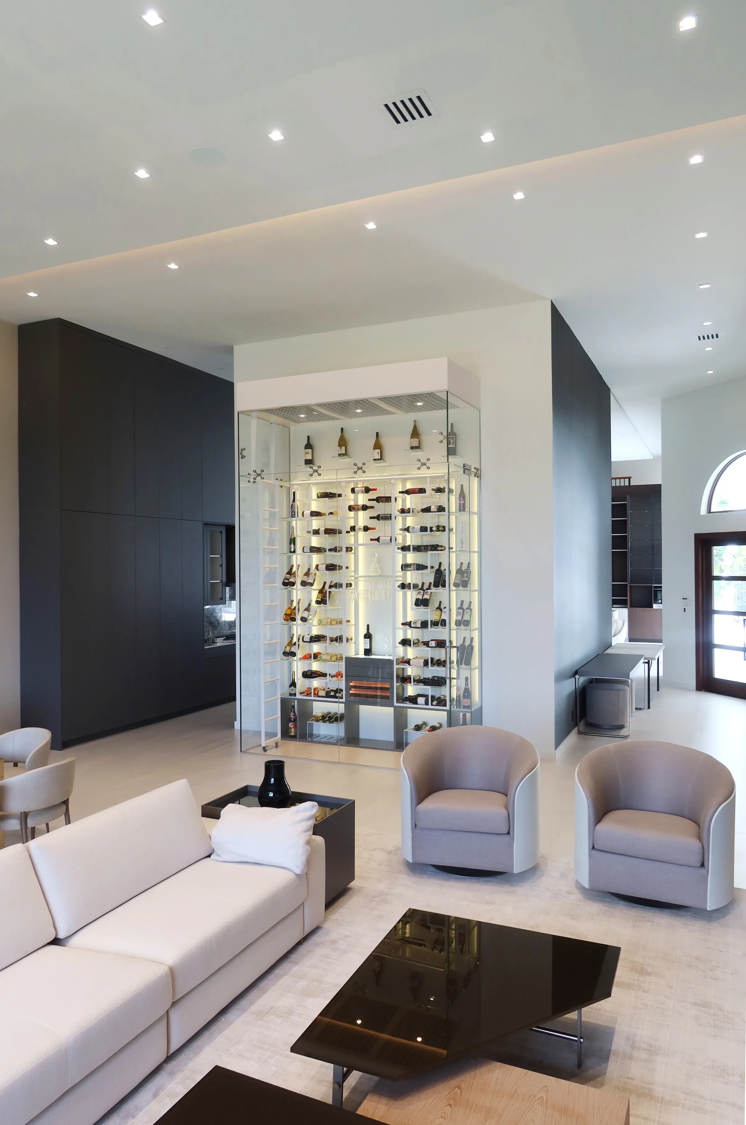 Luxury glass wine cellar Miami featuring custom floor-to-ceiling metal wine racks, LED lighting, and humidor — photograph 5 of 6