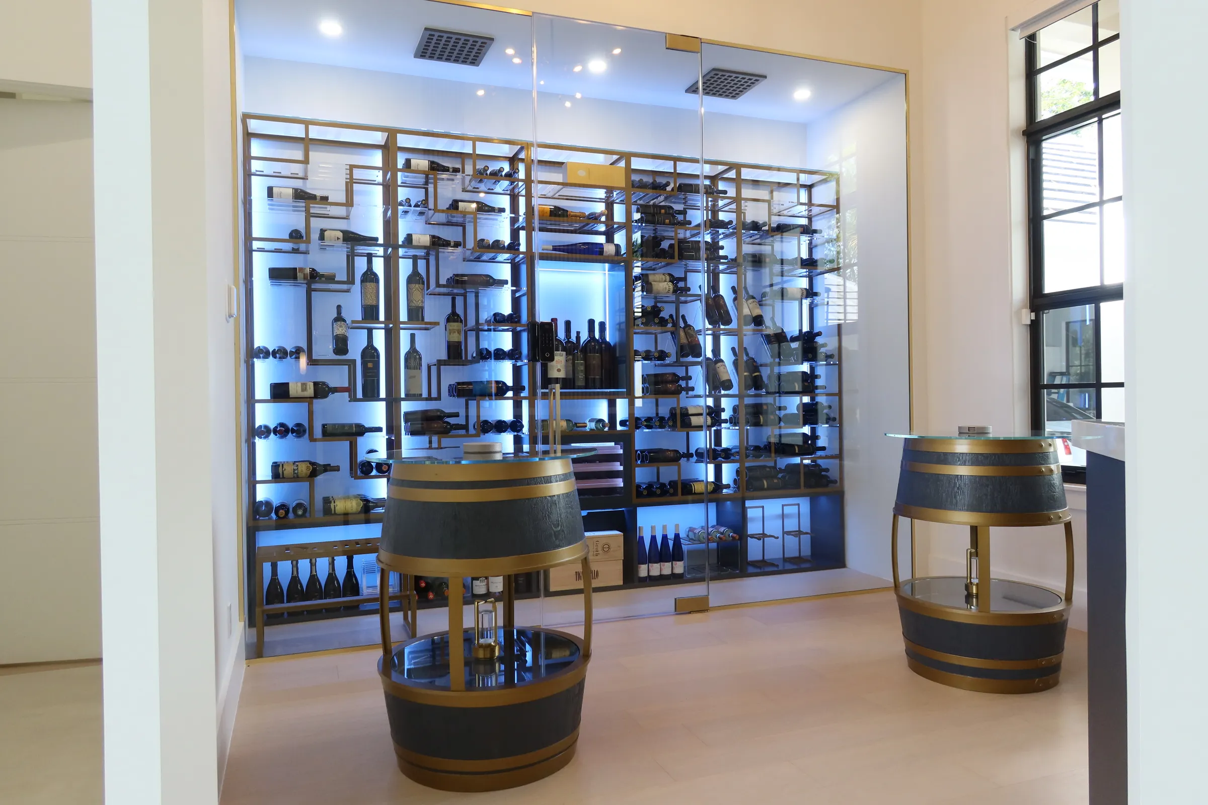 Luxury glass wine cellar Miami featuring custom floor-to-ceiling metal and wooden wine racks, and LED lighting — photograph 2 of 4