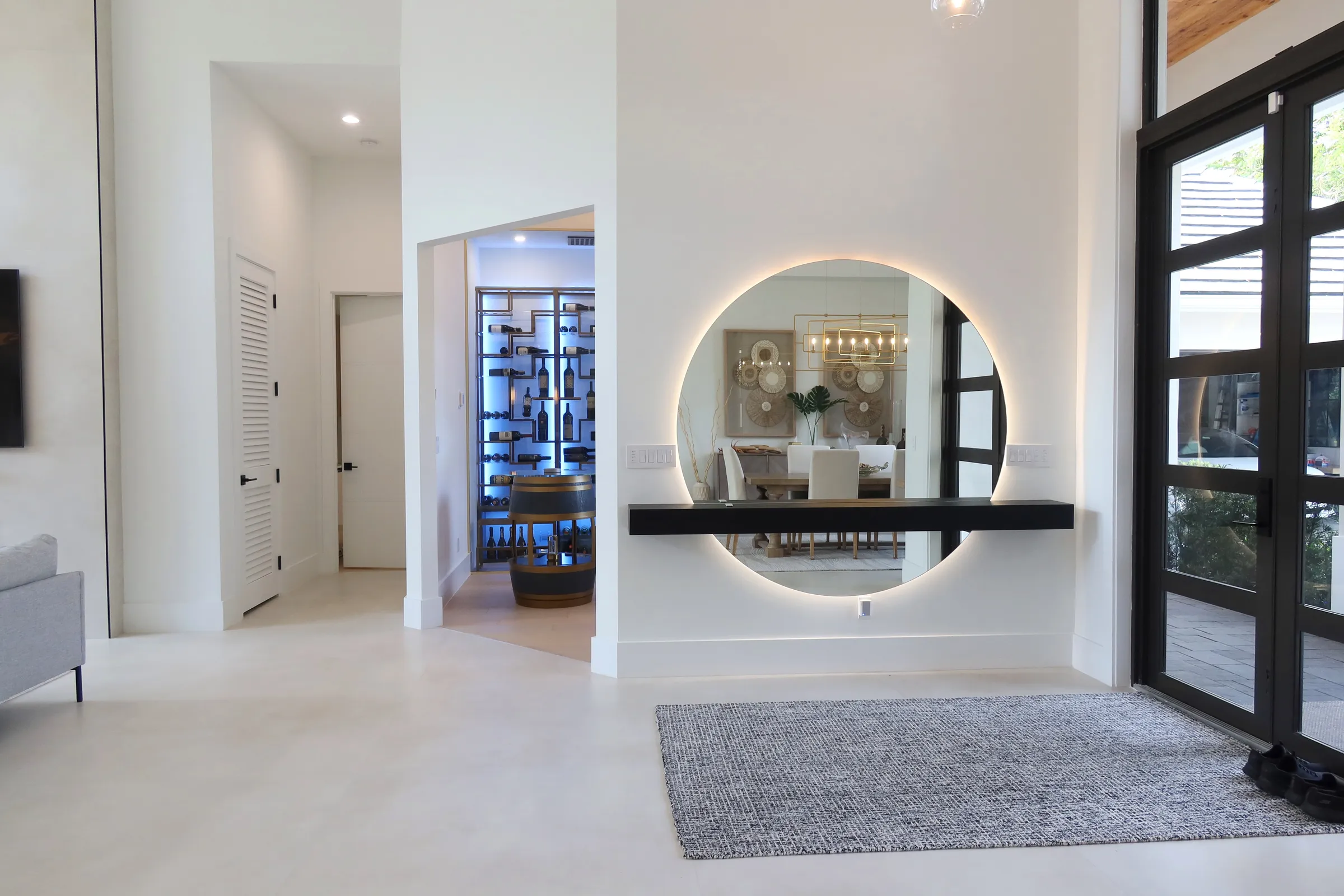 Luxury glass wine cellar Miami featuring custom floor-to-ceiling metal and wooden wine racks, and LED lighting — photograph 3 of 4