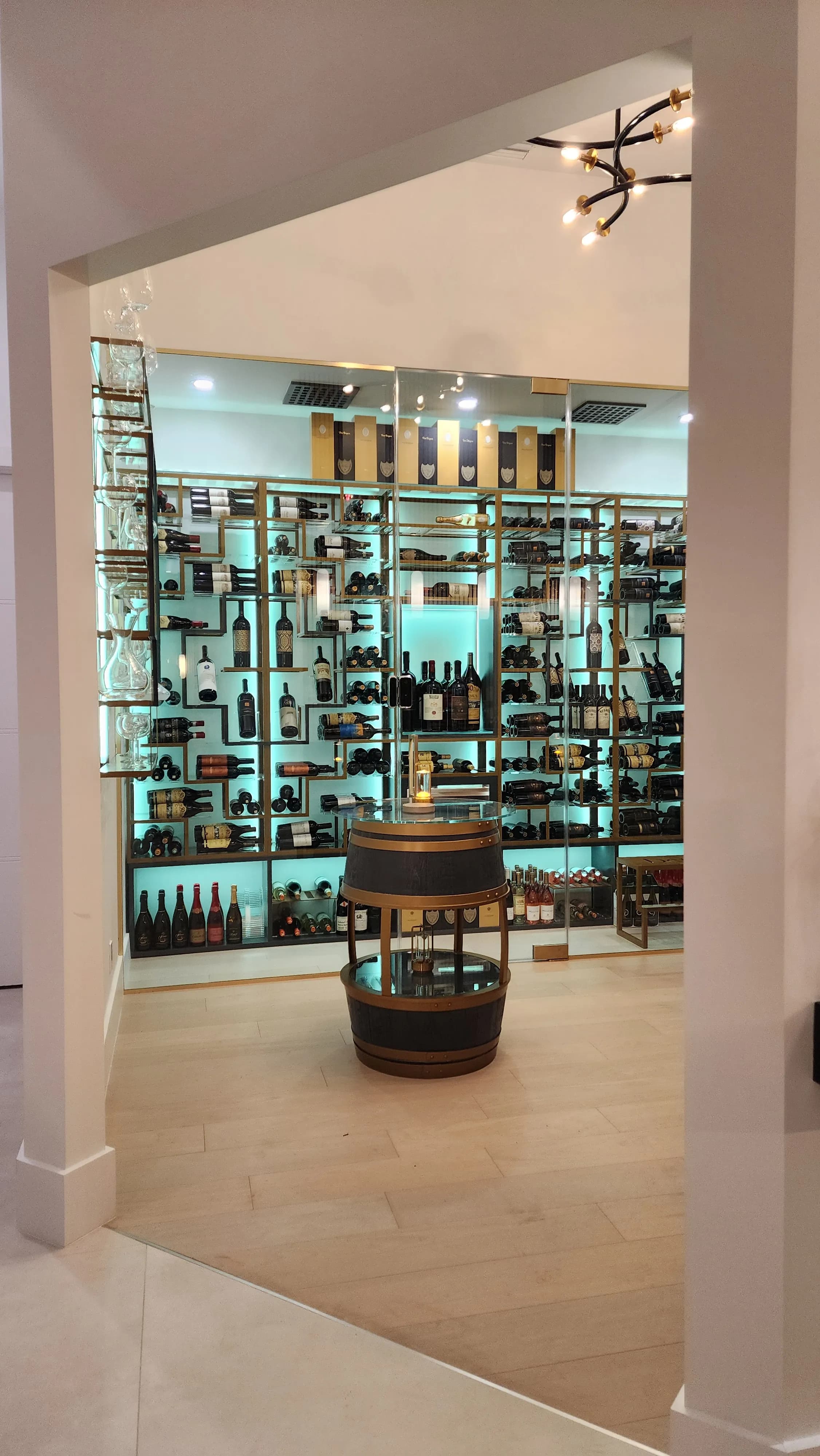 Luxury glass wine cellar Miami featuring custom floor-to-ceiling metal and wooden wine racks, and LED lighting — photograph 4 of 4