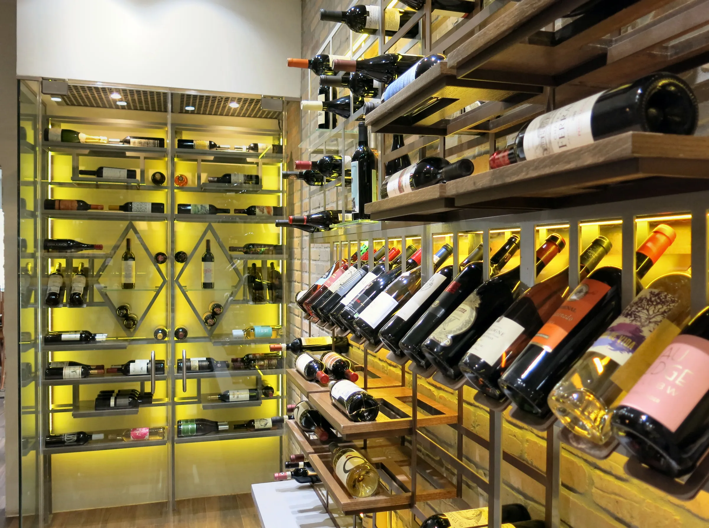 Luxury wine room Miami featuring custom floor-to-ceiling metal wine racks, and LED lighting, modern style — photograph 3 of 5