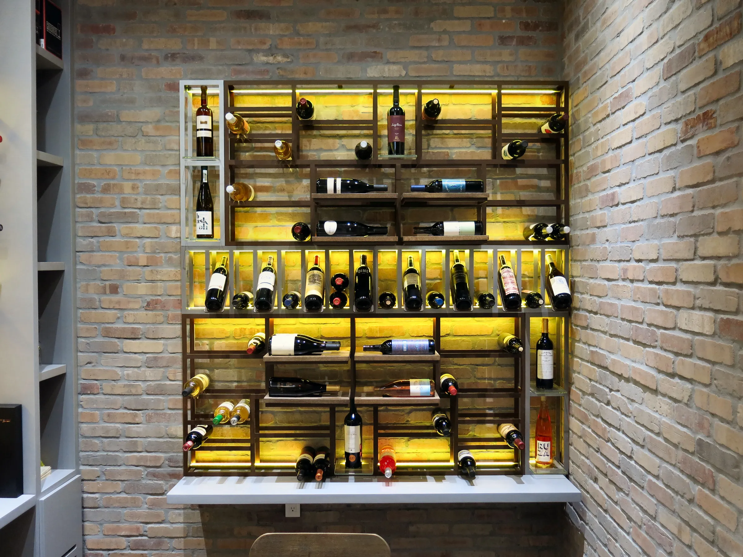 Luxury wine room Miami featuring custom floor-to-ceiling metal wine racks, and LED lighting, modern style — photograph 5 of 5