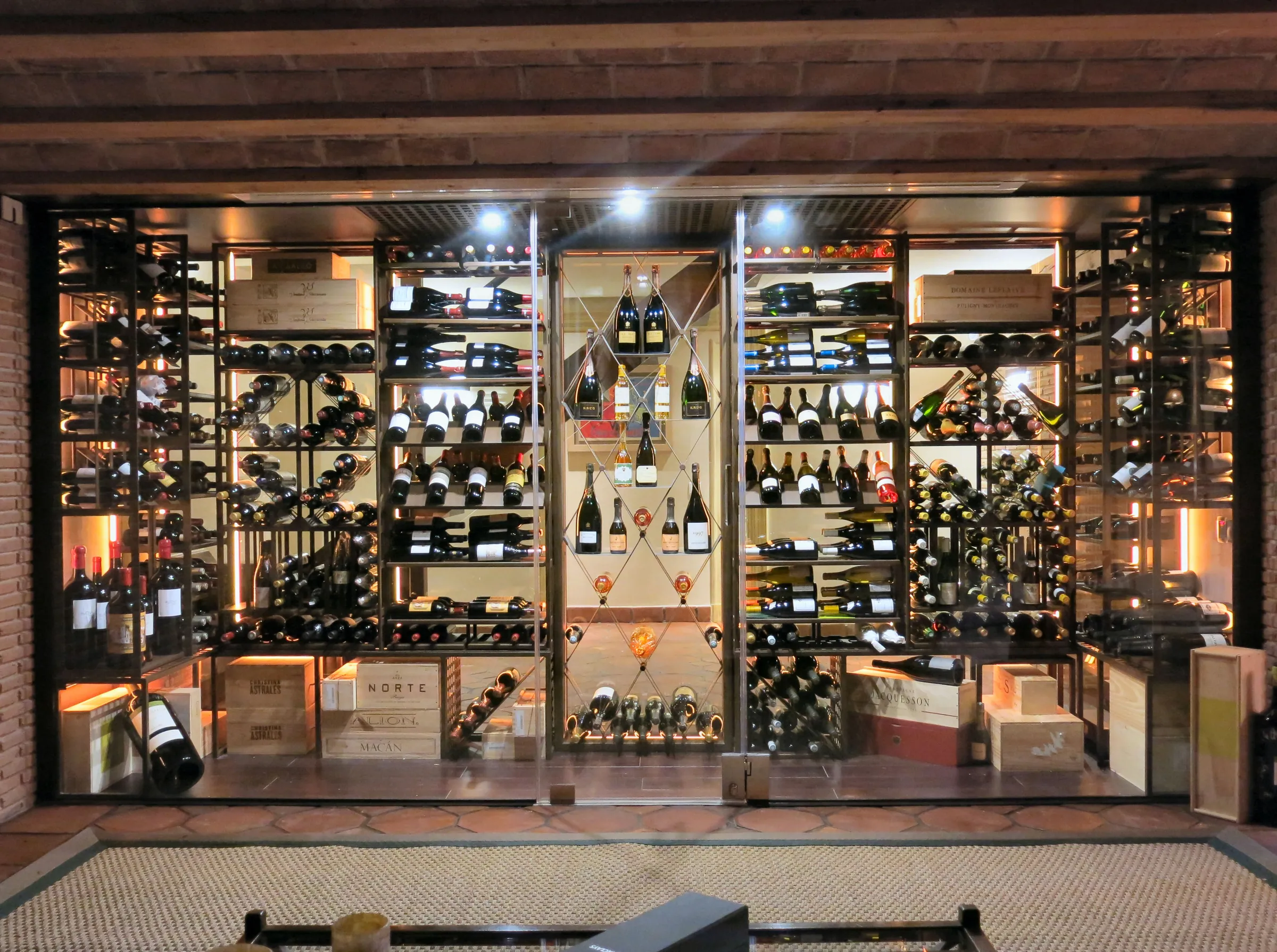 Understairs wine cellar, premium metal wine racks, luxury residential wine room — photograph 1 of 3