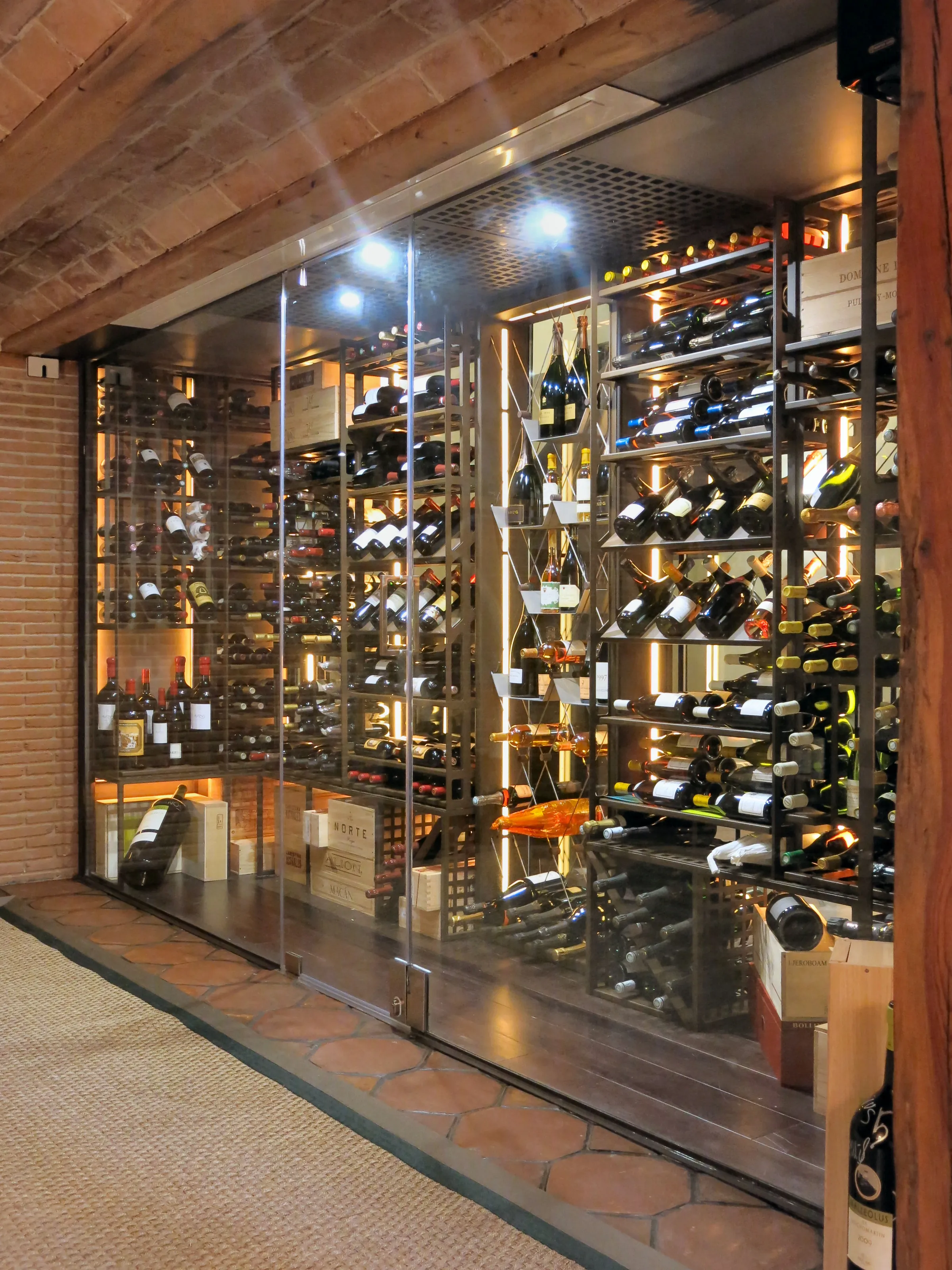 Understairs wine cellar, premium metal wine racks, luxury residential wine room — photograph 2 of 3