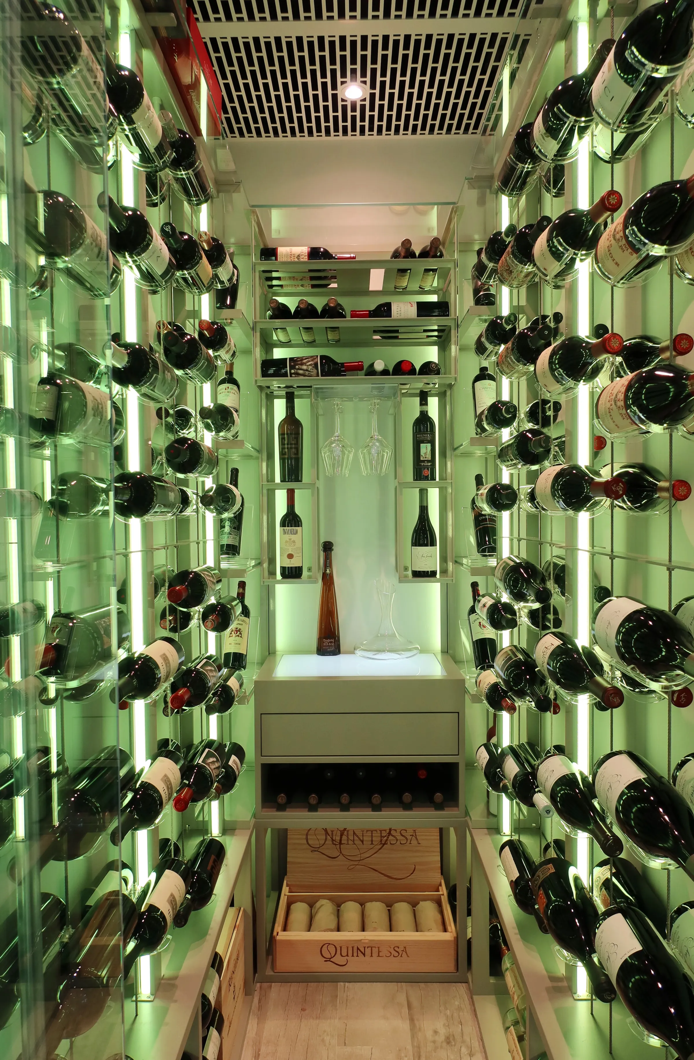 Luxury glass wine cellar Miami featuring custom metal wine racks, LED lighting, and floor-to-ceiling wine storage — photograph 1 of 4