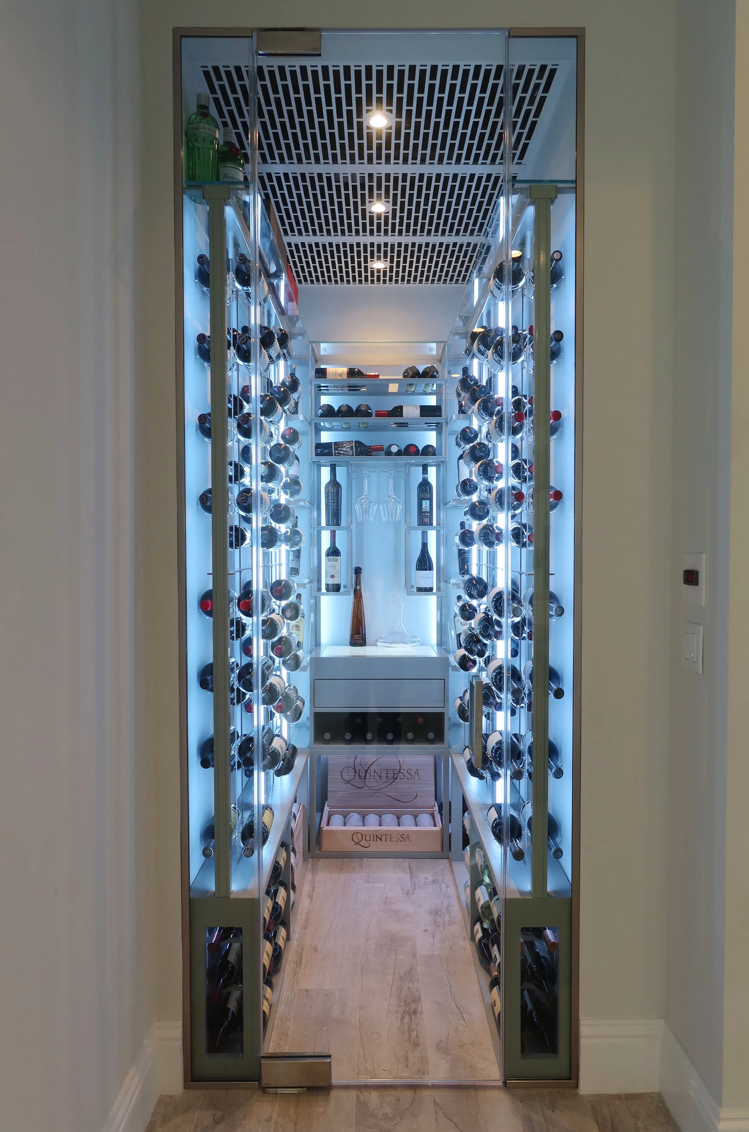 Luxury glass wine cellar Miami featuring custom metal wine racks, LED lighting, and floor-to-ceiling wine storage — photograph 2 of 4