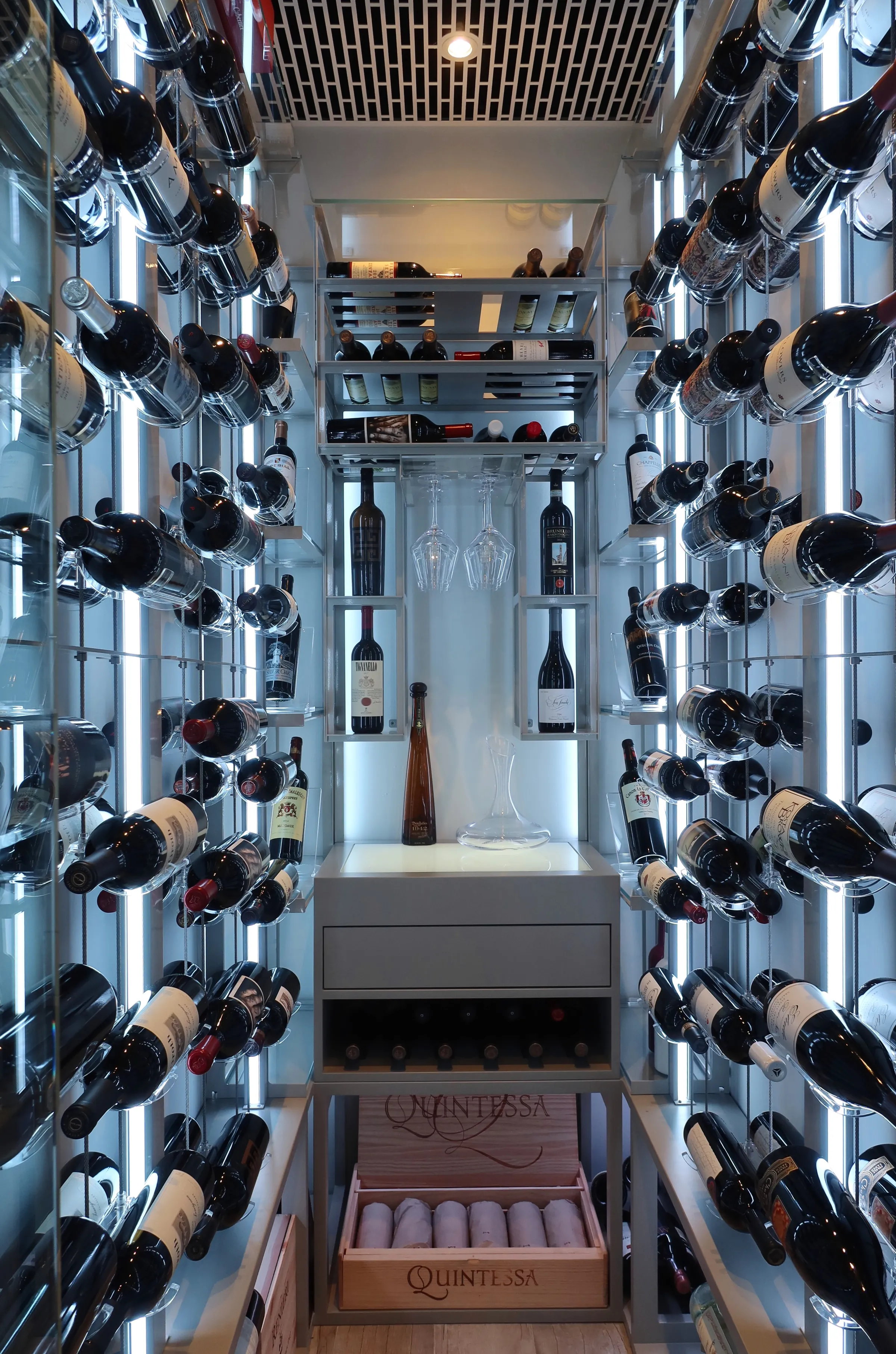 Luxury glass wine cellar Miami featuring custom metal wine racks, LED lighting, and floor-to-ceiling wine storage — photograph 3 of 4