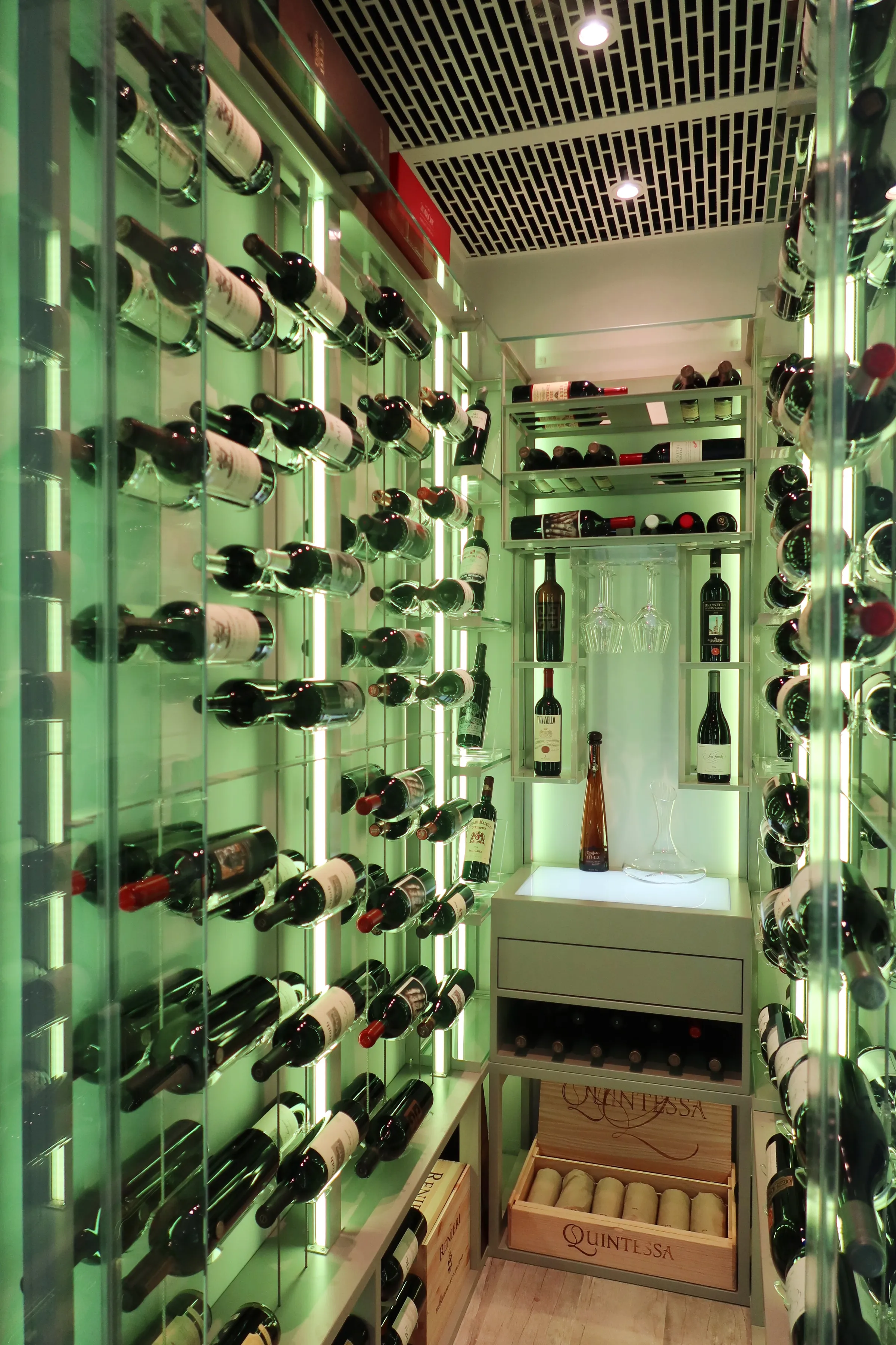 Luxury glass wine cellar Miami featuring custom metal wine racks, LED lighting, and floor-to-ceiling wine storage — photograph 4 of 4