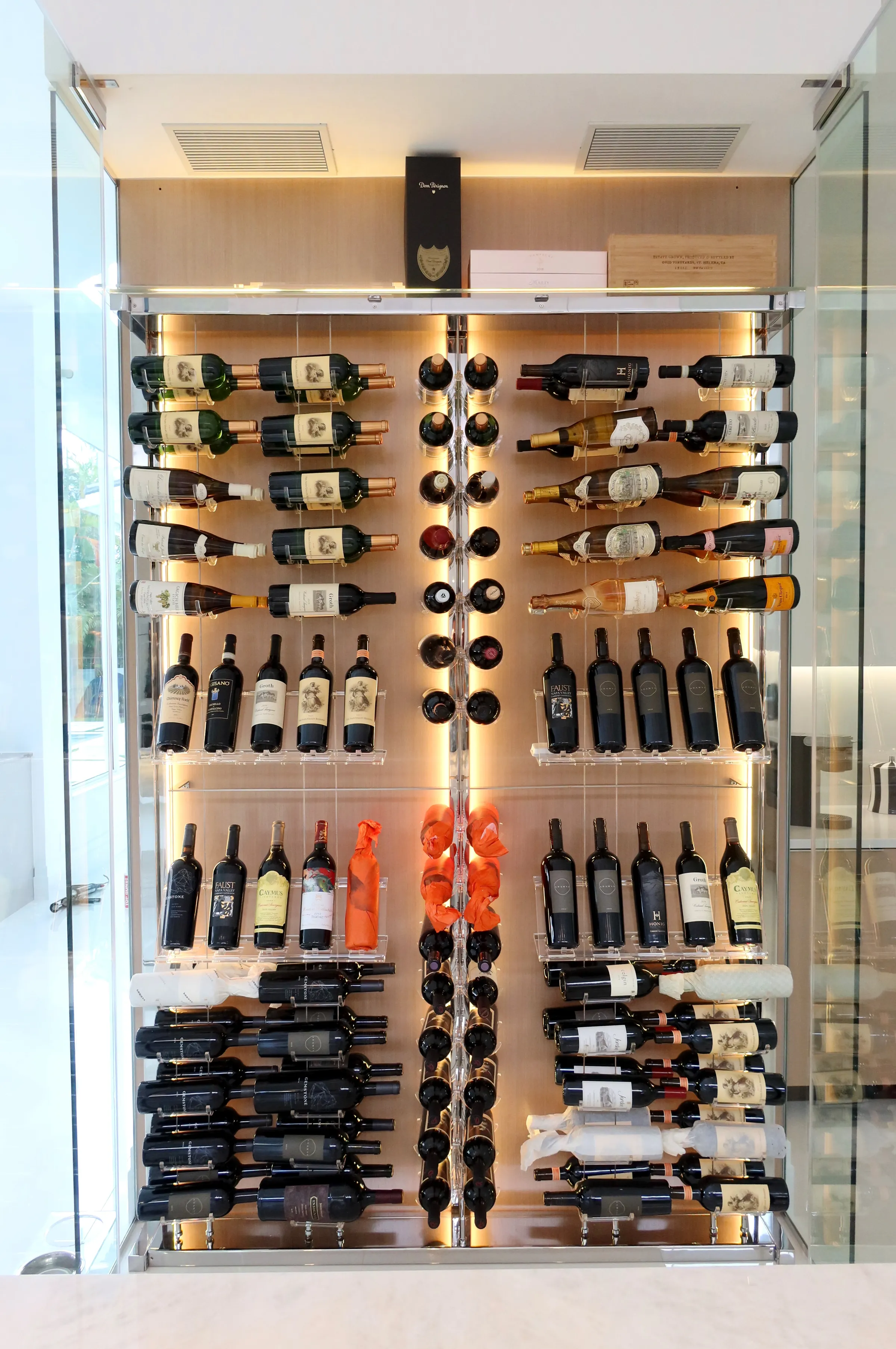 Modern Wine Wall Jupiter Florida - kitchen-integrated cable system racks, acrylic hooks, floating effect, LED strips, wooden back panel — photograph 1 of 3