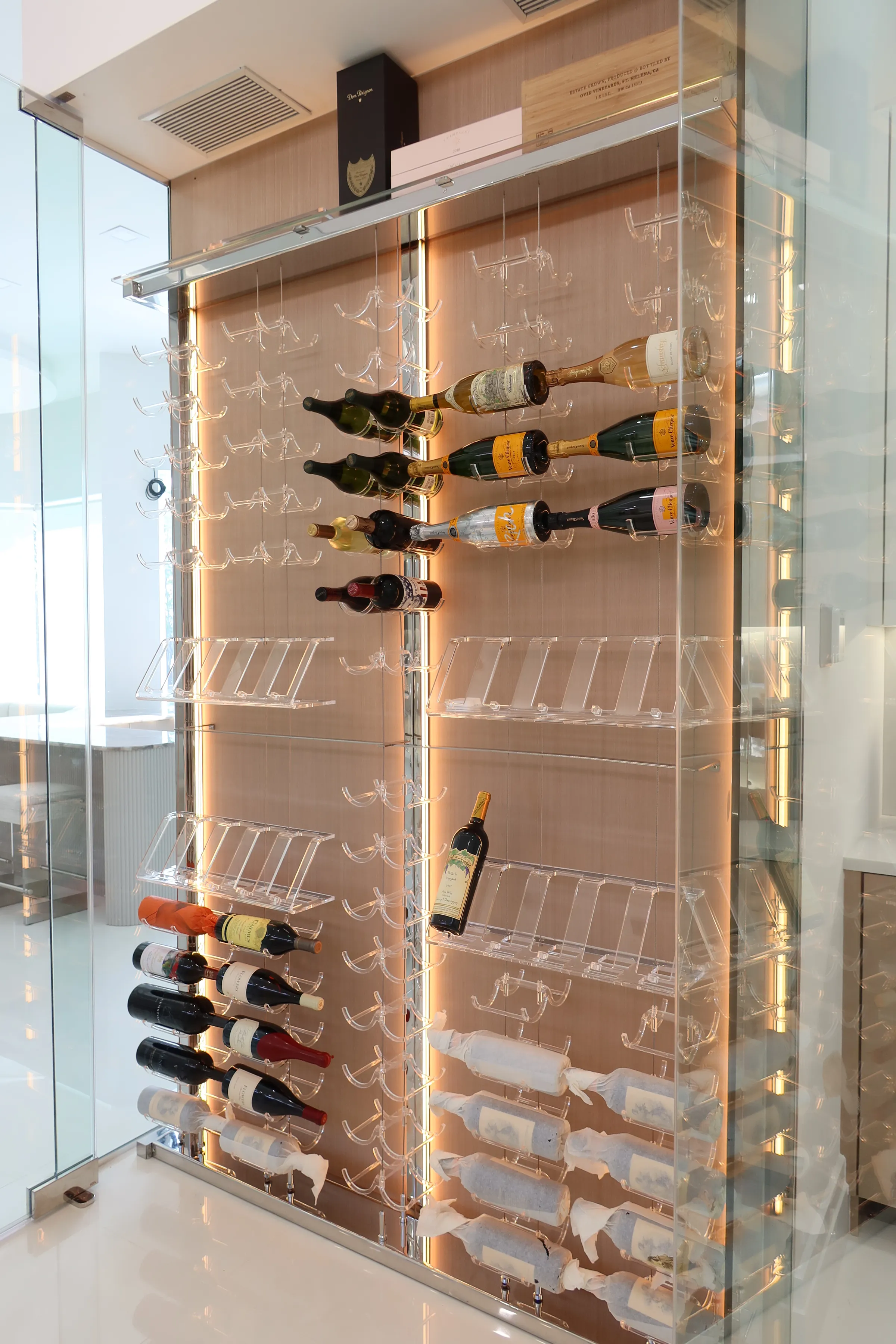 Modern Wine Wall Jupiter Florida - kitchen-integrated cable system racks, acrylic hooks, floating effect, LED strips, wooden back panel — photograph 3 of 3