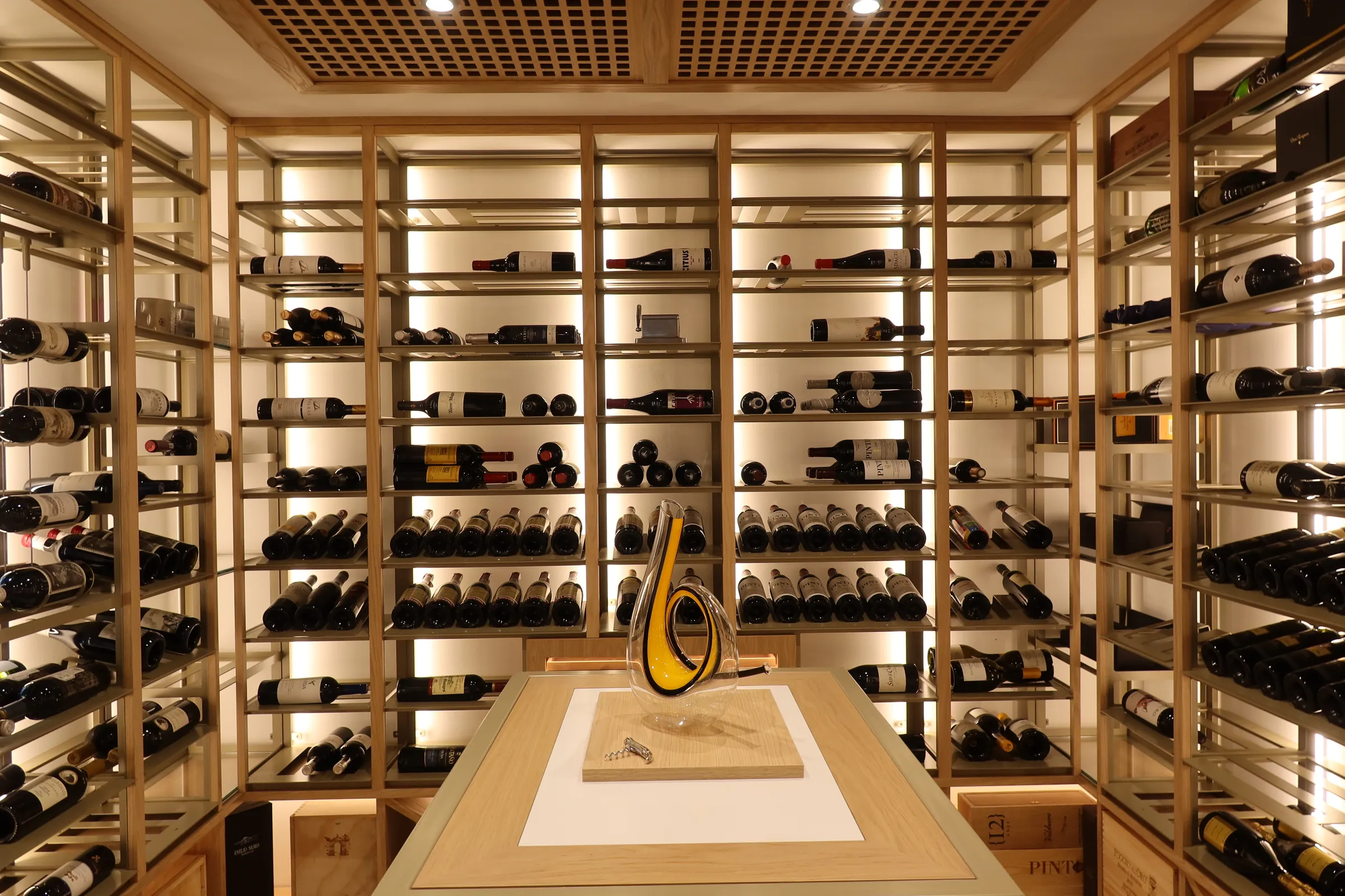 Luxury home wine cellar Florida warm wood finishes ambient lighting Bella Vista