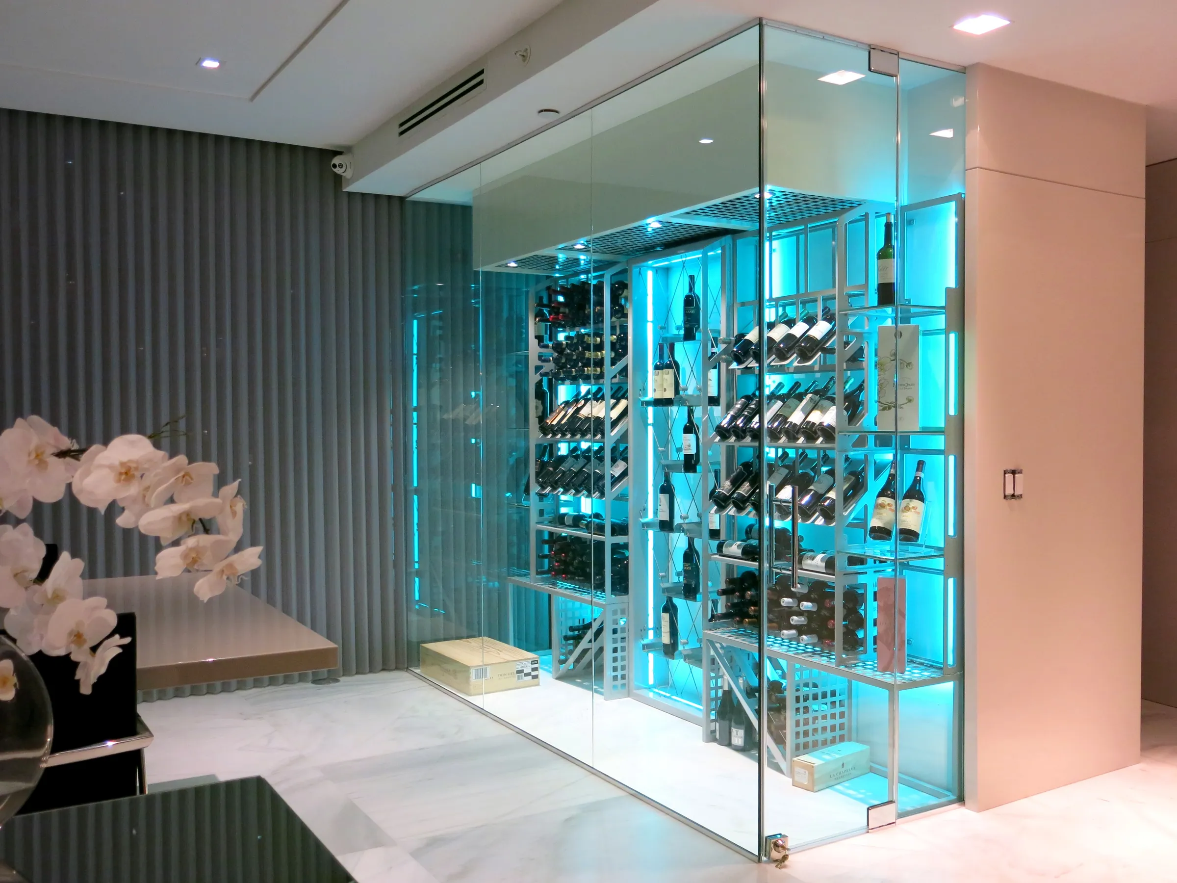 Custom wine cellar Miami featuring glass enclosure, illuminated bottle displays, and modern luxury wine storage — photograph 3 of 3