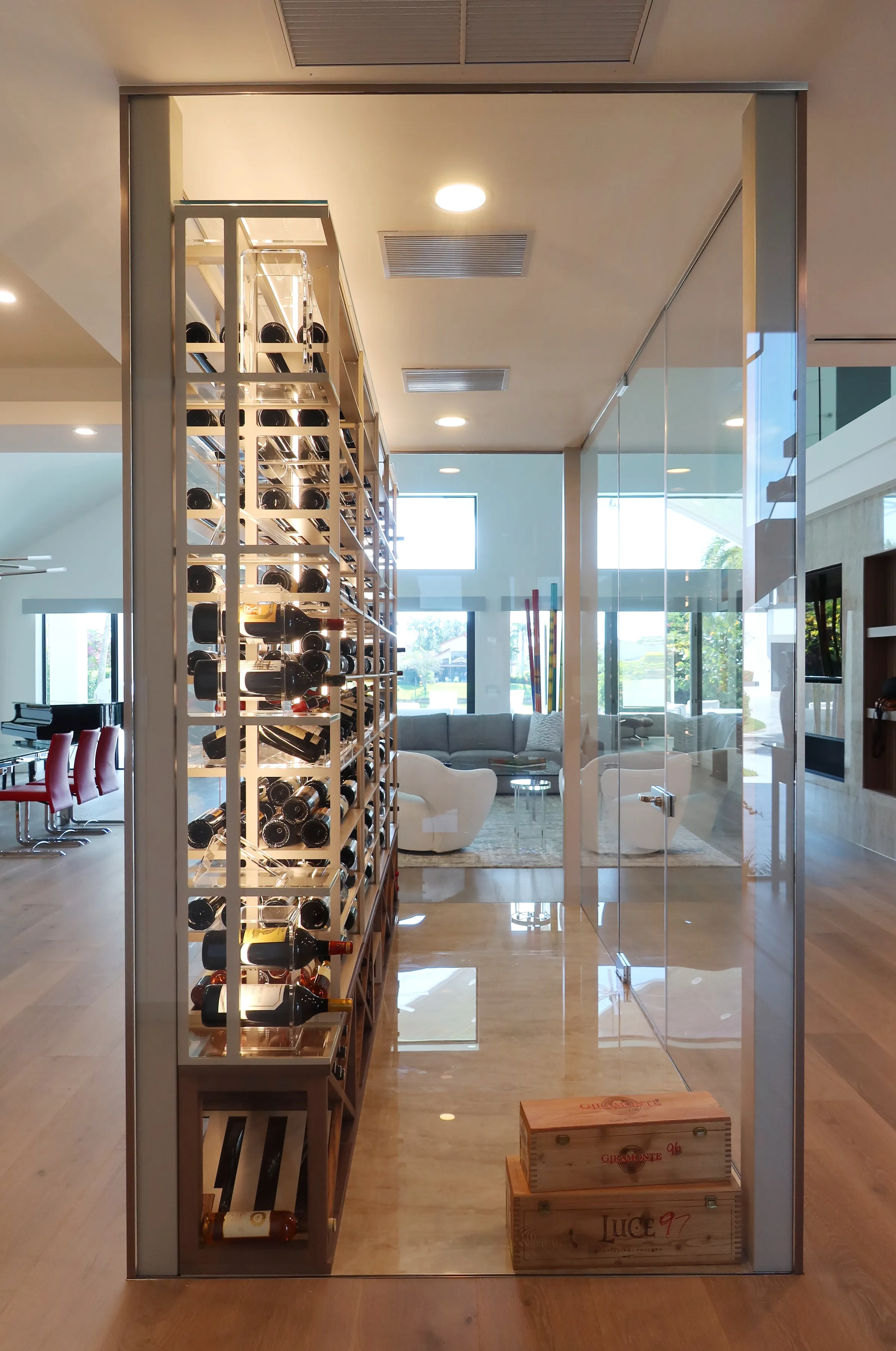 Luxury glass wine cellar Miami featuring custom metal and wooden wine racks, LED lighting, and floor-to-ceiling wine storage — photograph 1 of 9