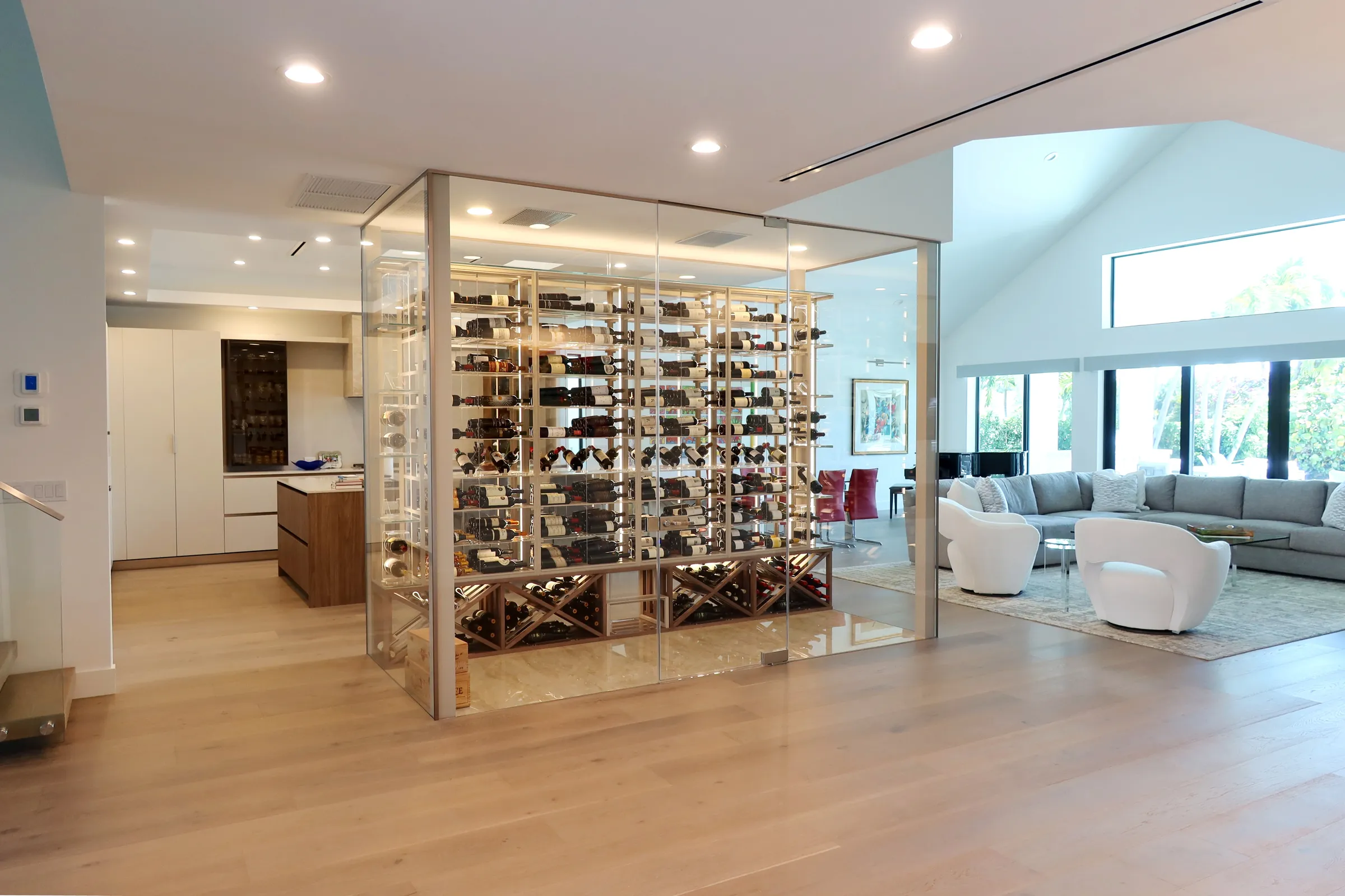 Luxury glass wine cellar Miami featuring custom metal and wooden wine racks, LED lighting, and floor-to-ceiling wine storage — photograph 2 of 9