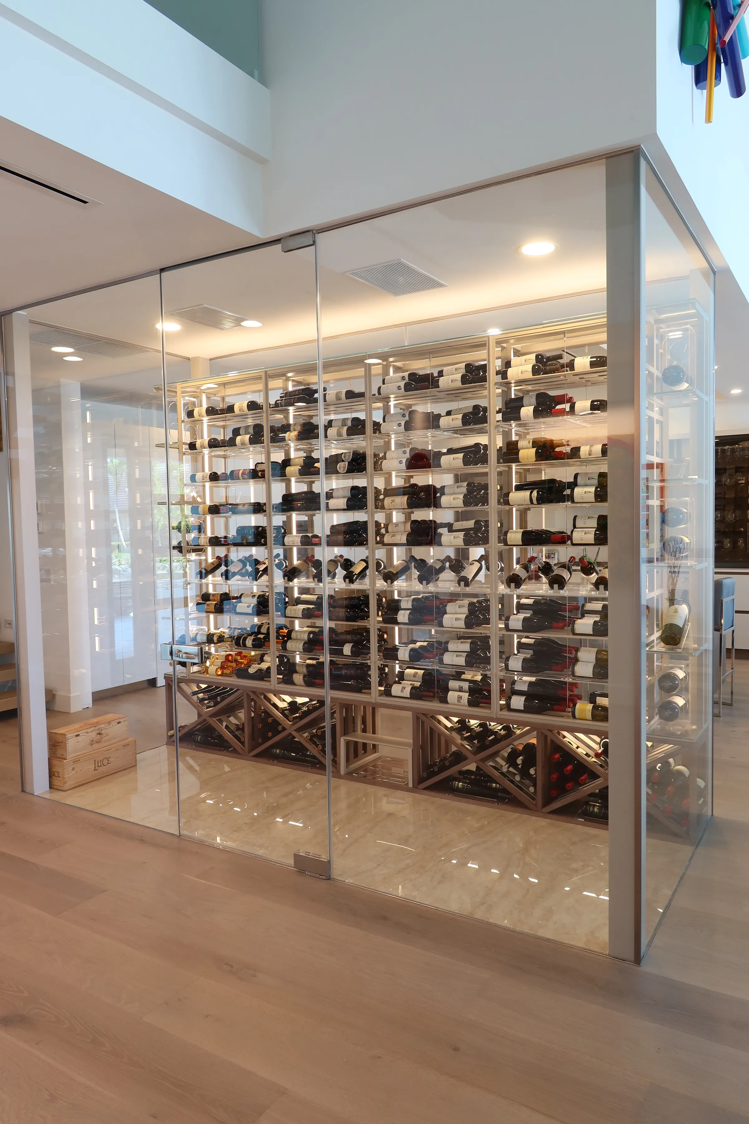 Luxury glass wine cellar Miami featuring custom metal and wooden wine racks, LED lighting, and floor-to-ceiling wine storage — photograph 3 of 9