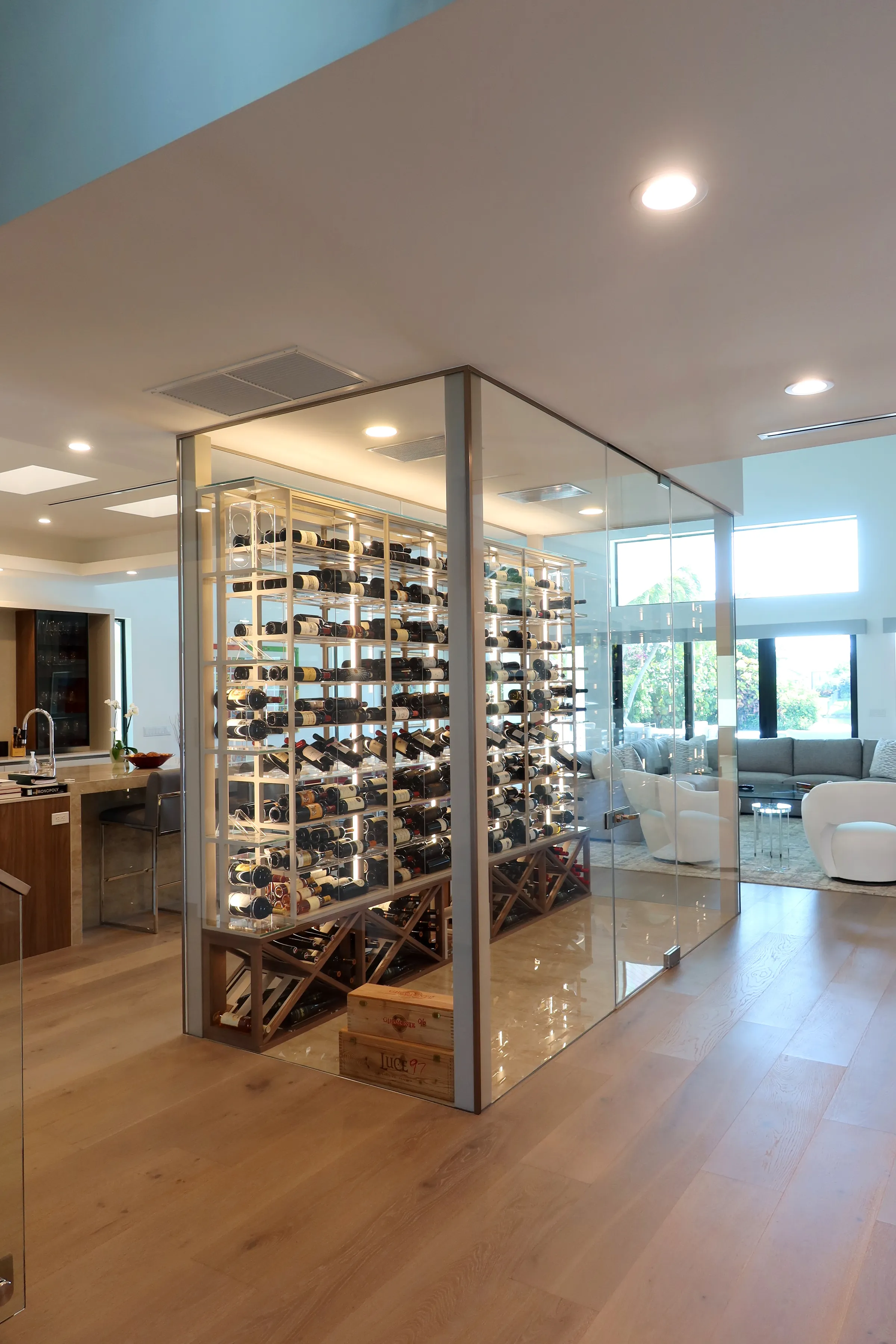 Luxury glass wine cellar Miami featuring custom metal and wooden wine racks, LED lighting, and floor-to-ceiling wine storage — photograph 5 of 9