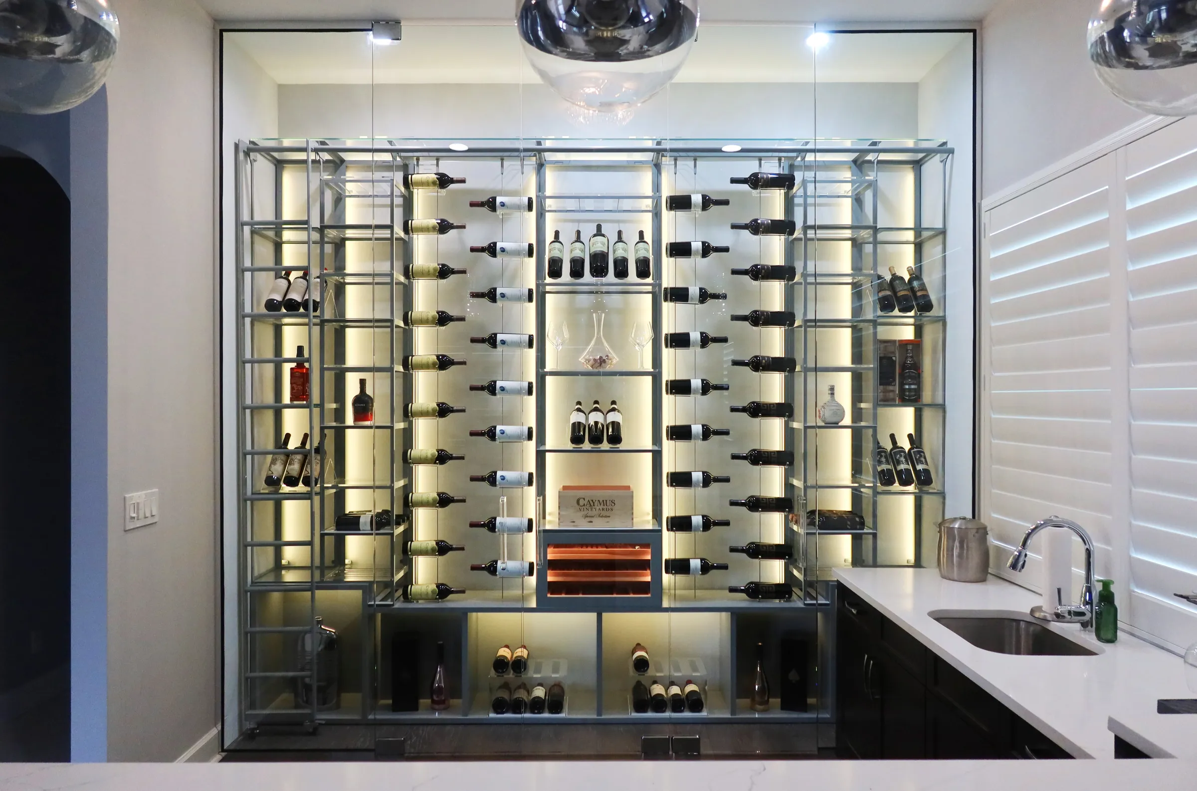 Custom wine wall Miami featuring glass enclosure, illuminated bottle displays, and contemporary luxury wine storage — photograph 4 of 4