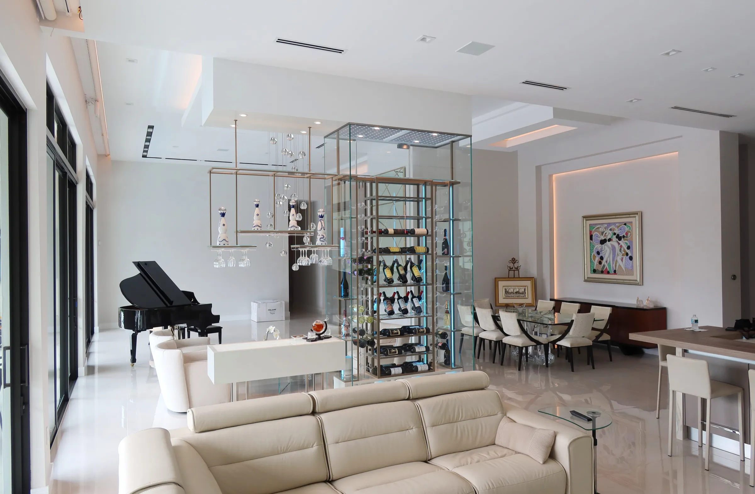 Luxury total glass wine cellar Miami featuring custom floor-to-ceiling metal and wooden wine racks, and LED lighting — photograph 2 of 4