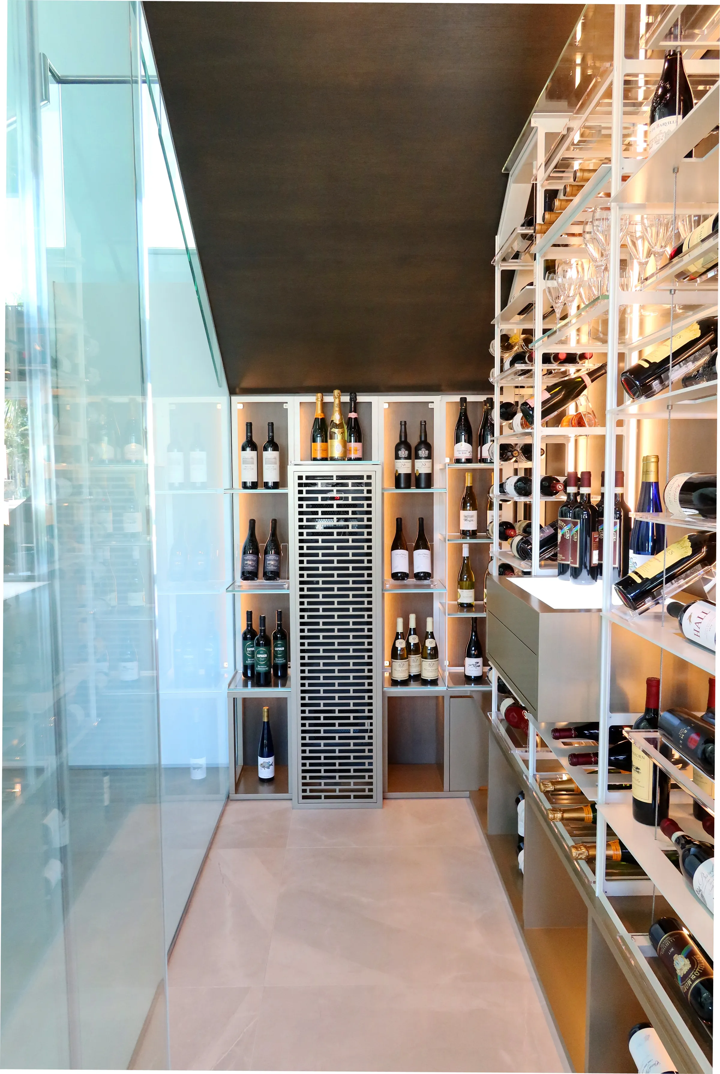 understairs wine room in south Florida, glass enclosures, wall-mounted metal wine racks, contemporary wine cellar design, luxury wine storage — photograph 2 of 4