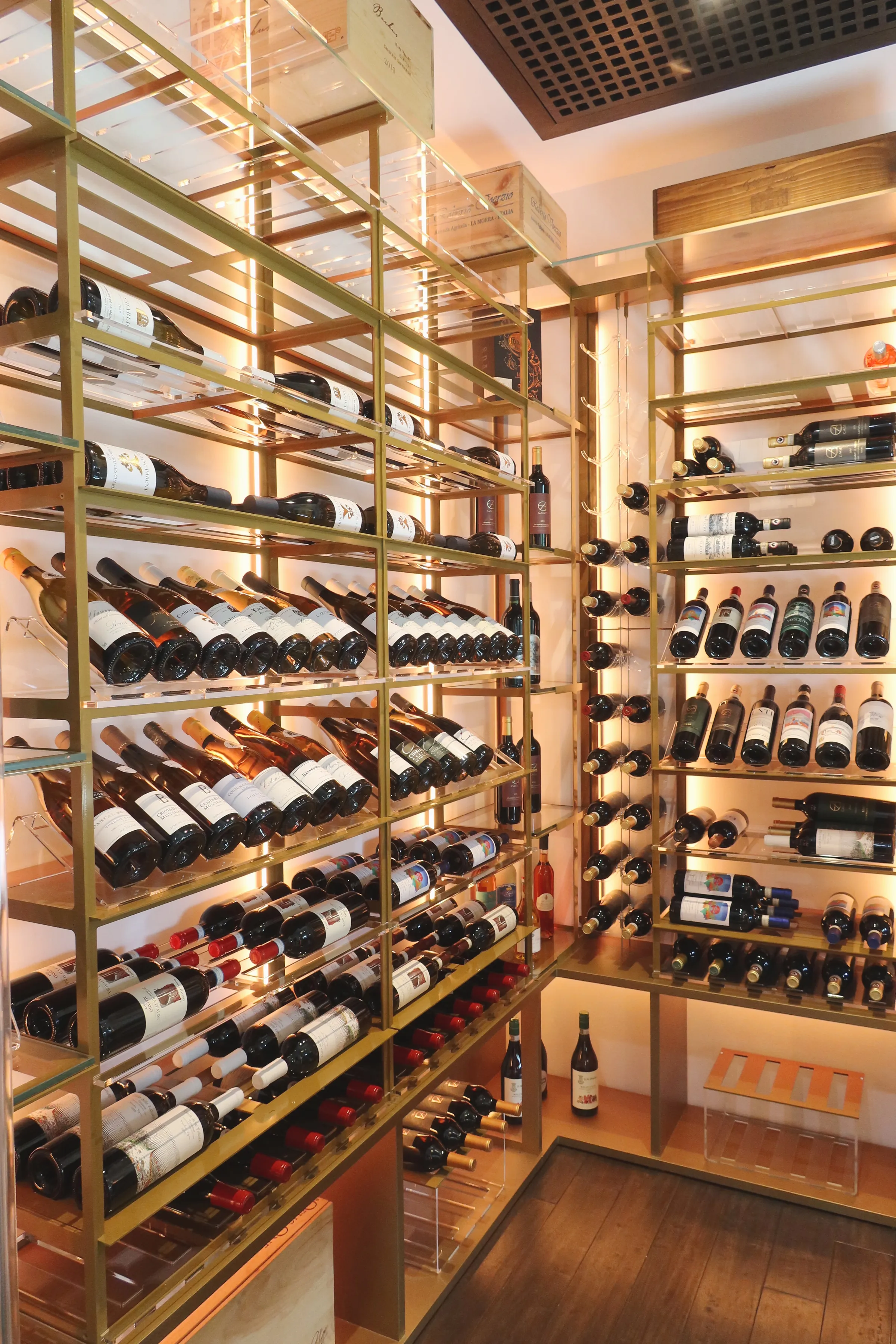 Luxury glass wine cellar Miami featuring custom metal wine racks, LED lighting, and floor-to-ceiling wine storage — photograph 1 of 6