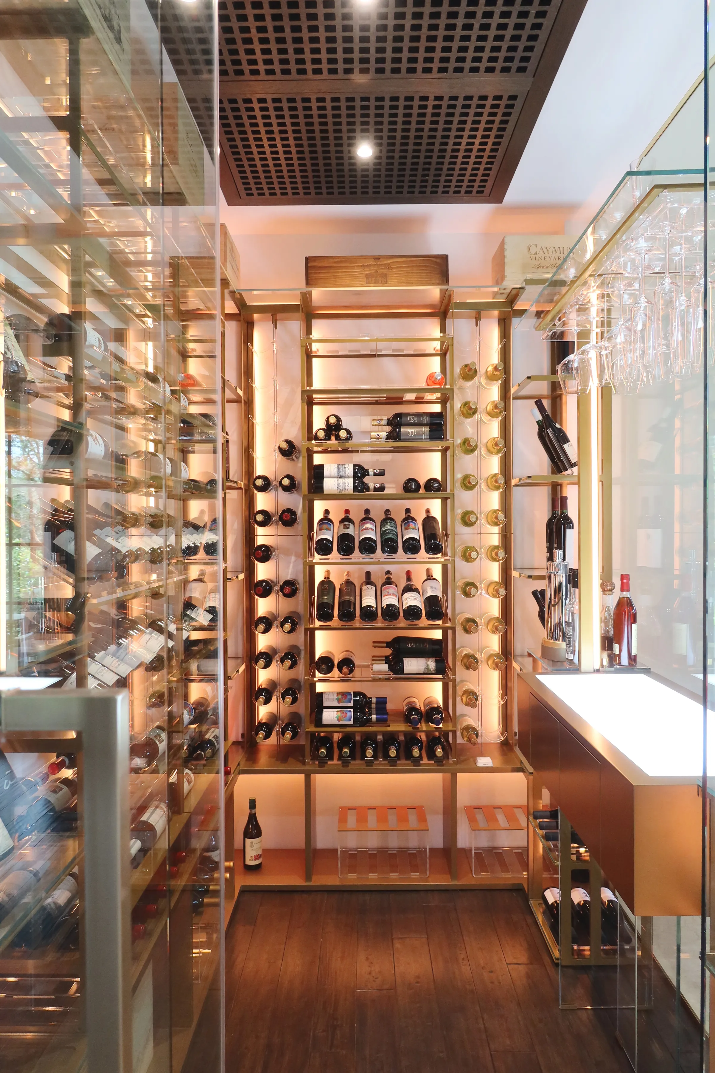 Luxury glass wine cellar Miami featuring custom metal wine racks, LED lighting, and floor-to-ceiling wine storage — photograph 2 of 6
