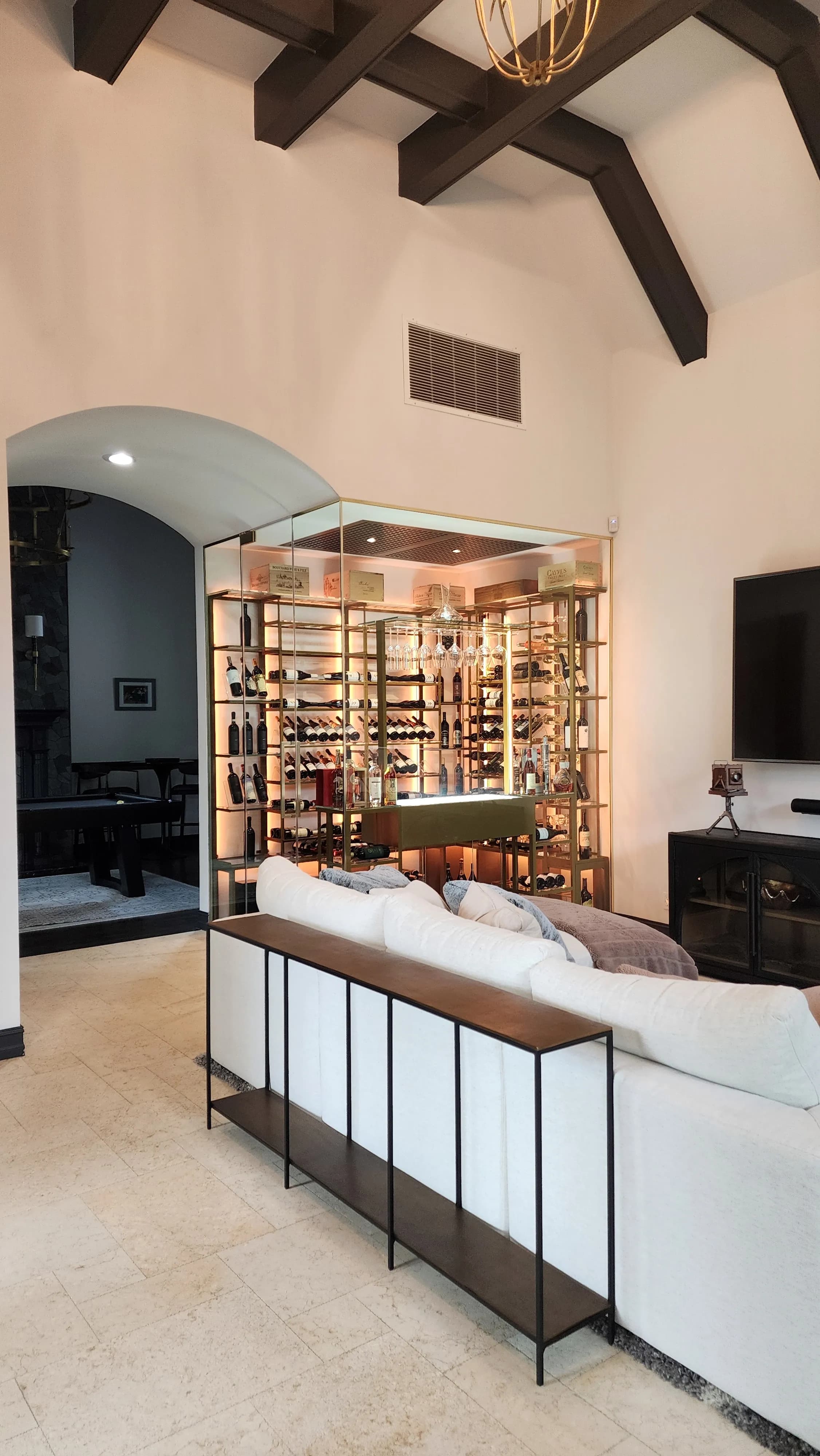 Luxury glass wine cellar Miami featuring custom metal wine racks, LED lighting, and floor-to-ceiling wine storage — photograph 6 of 6