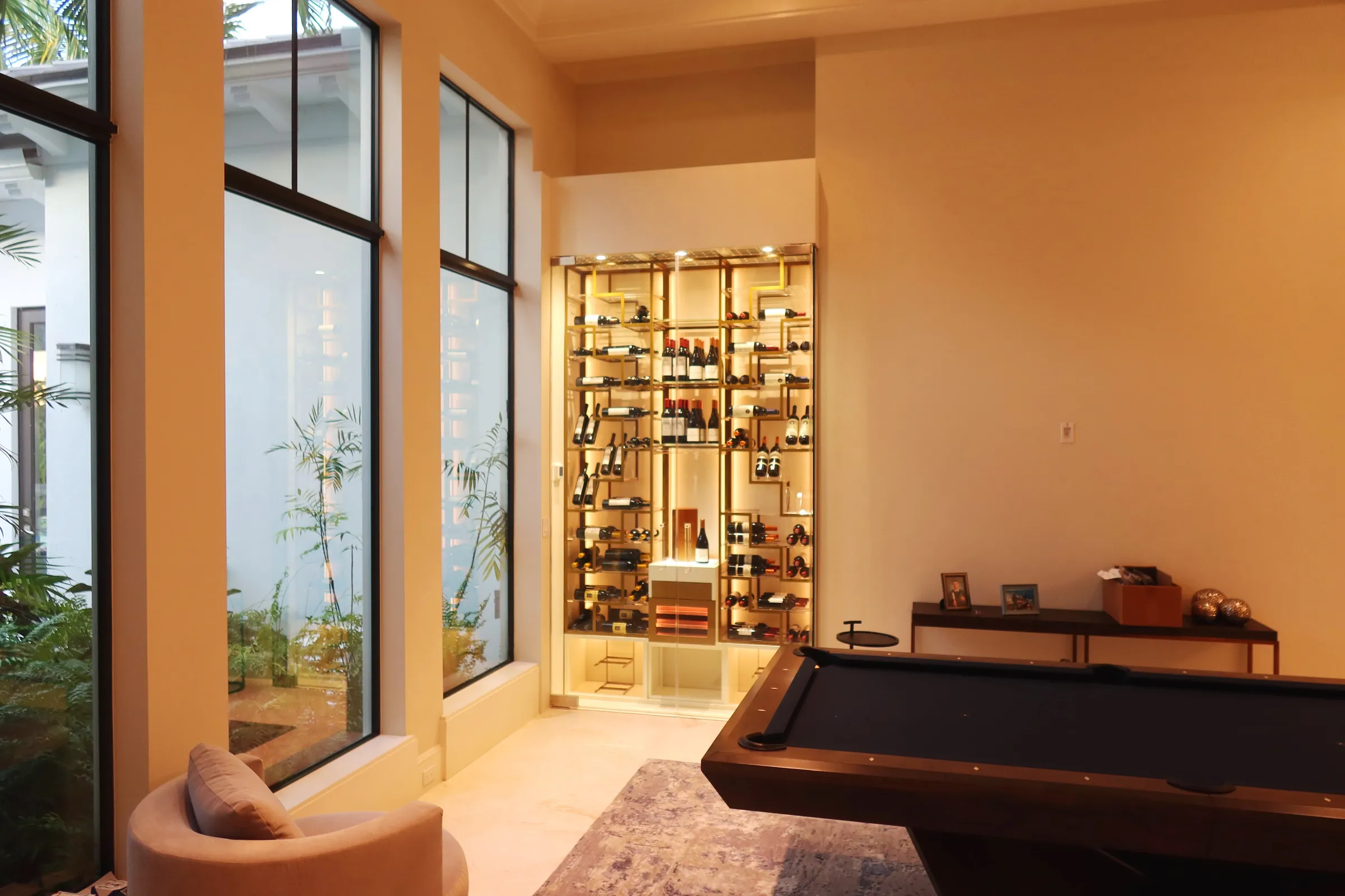 Custom wine wall Palm Beach featuring glass enclosure, illuminated bottle displays, and contemporary luxury wine storage — photograph 1 of 4
