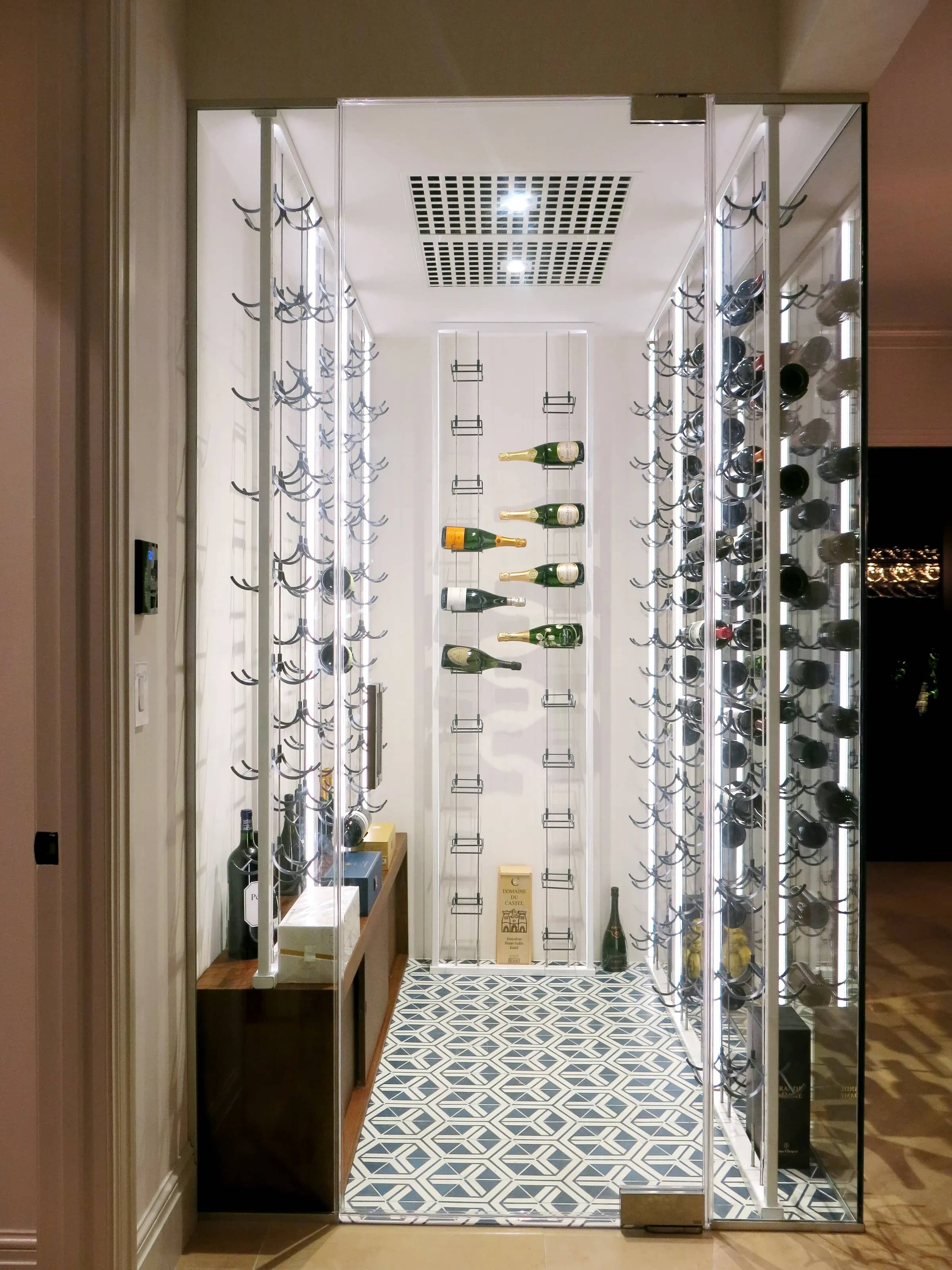 Luxury glass wine cellar Miami featuring custom floor-to-ceiling metal and wooden wine racks, and LED lighting — photograph 3 of 4