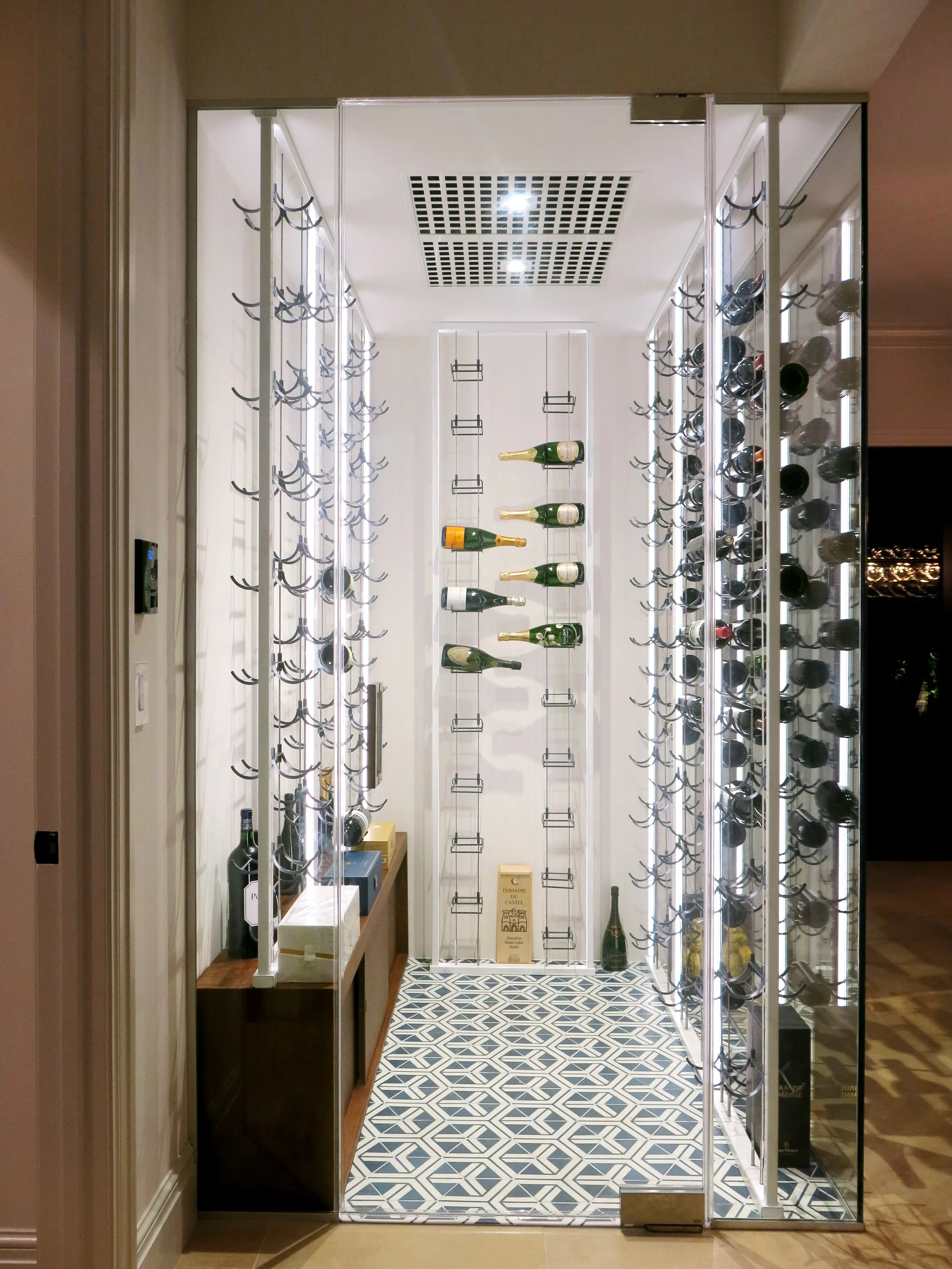 Luxury glass wine cellar Miami featuring custom floor-to-ceiling metal and wooden wine racks, and LED lighting — photograph 3 of 4