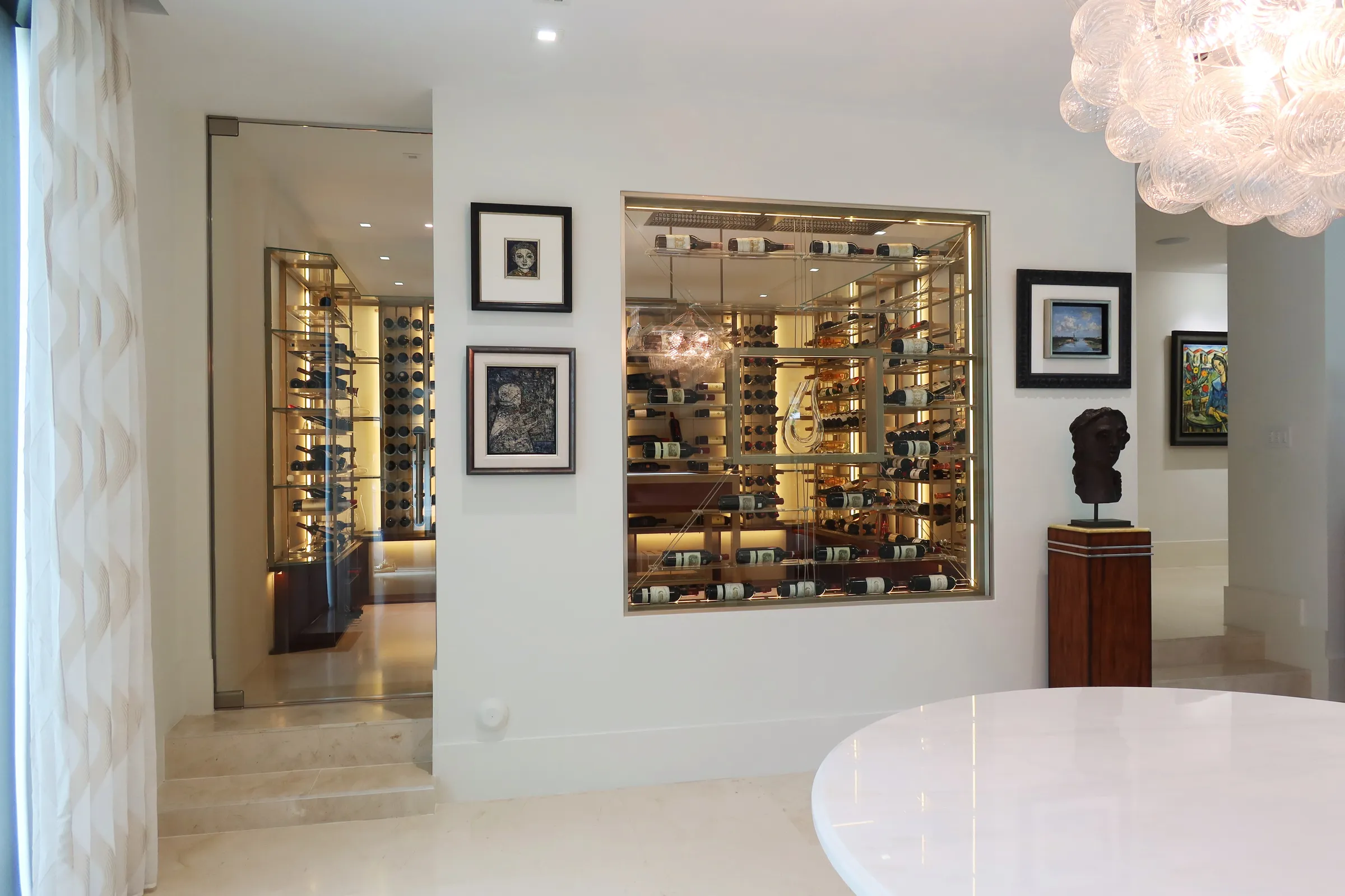 Luxury wine cellar Miami featuring custom floor-to-ceiling metal and wooden wine racks, LED lighting, and tasting table — photograph 2 of 4