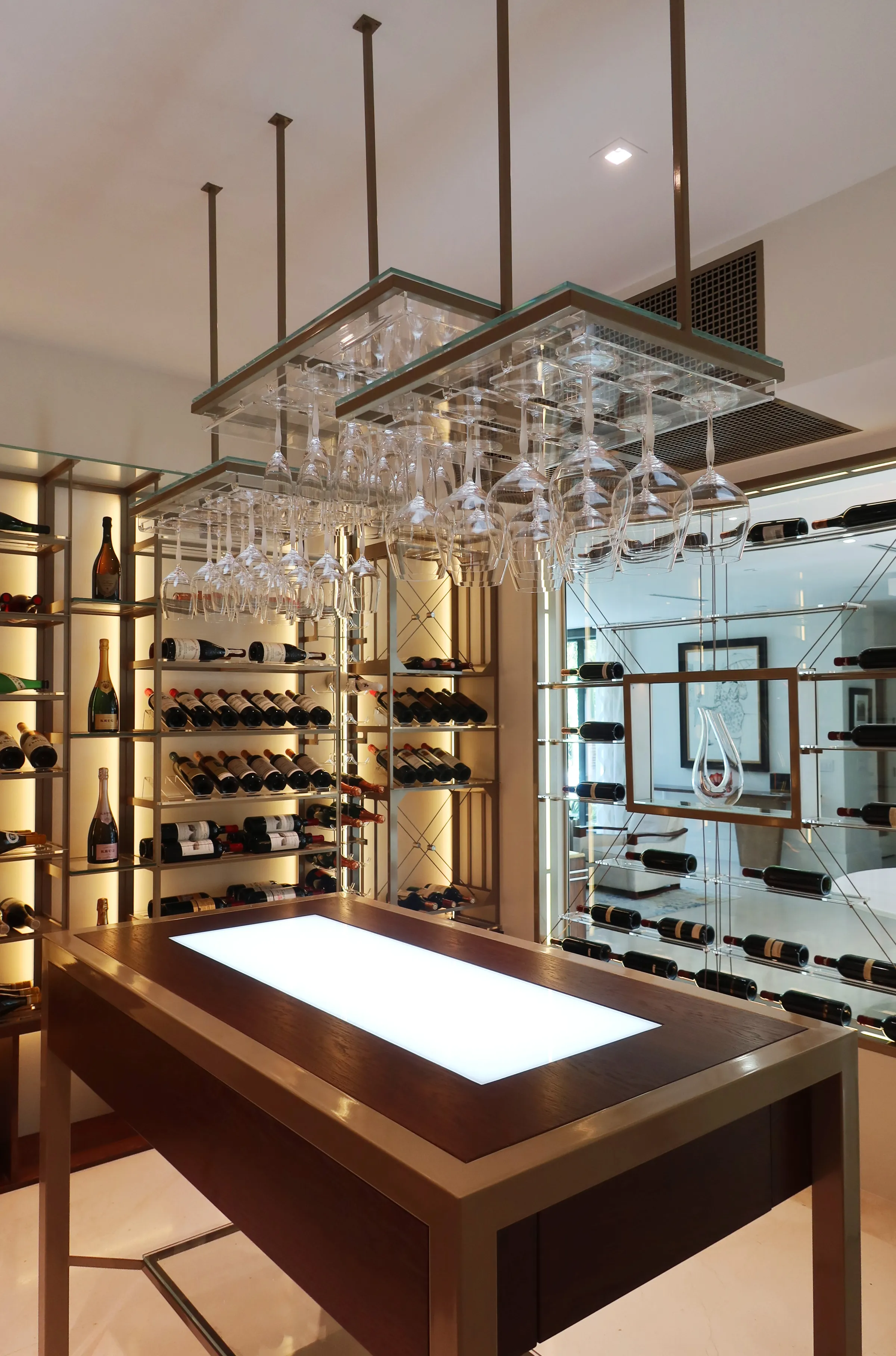Luxury wine cellar Miami featuring custom floor-to-ceiling metal and wooden wine racks, LED lighting, and tasting table — photograph 4 of 4